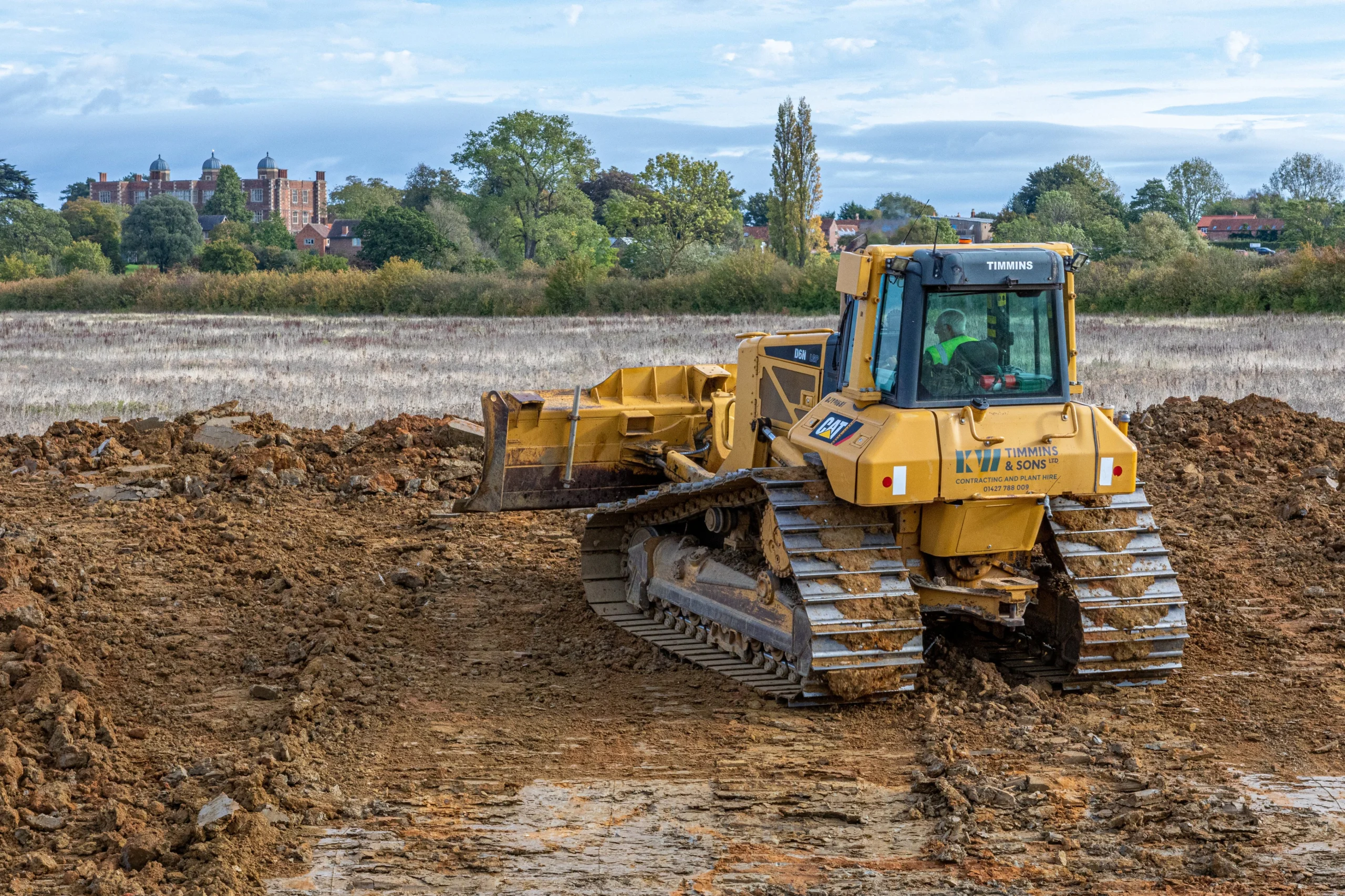 a digger removing soil for a new pond on doddington estate