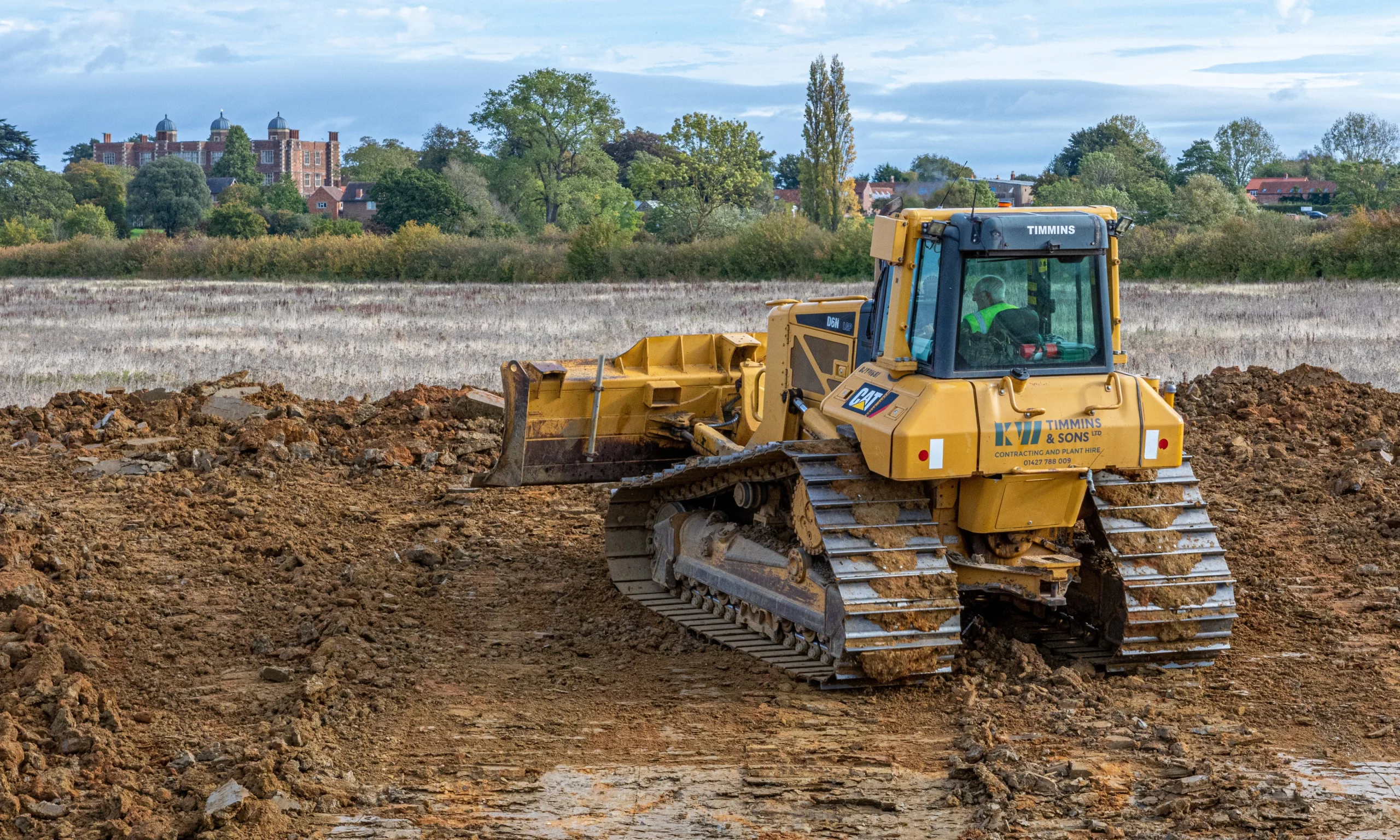 a digger removing soil for a new pond on doddington estate