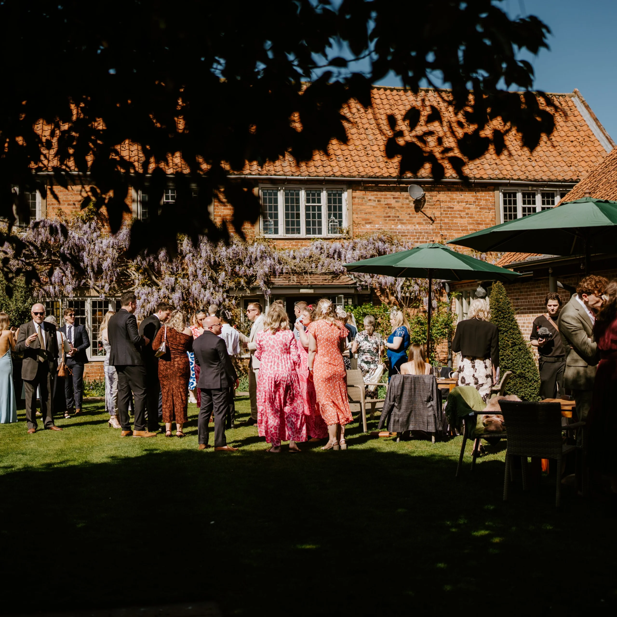 wedding guests at coach house garden doddington hall