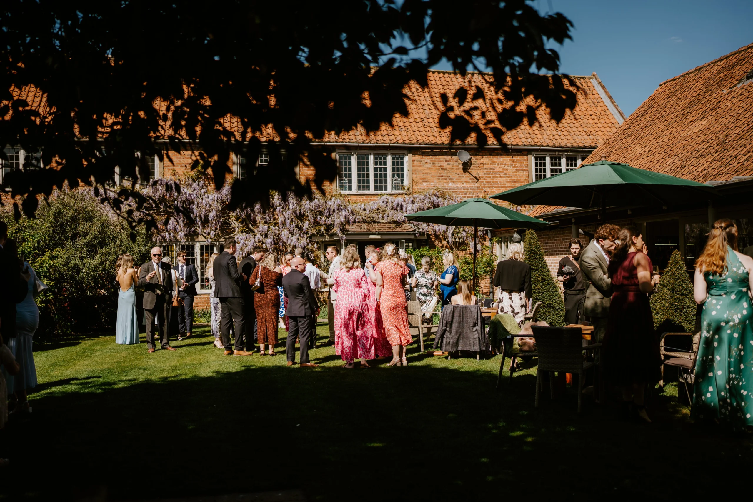 wedding guests at coach house garden doddington hall