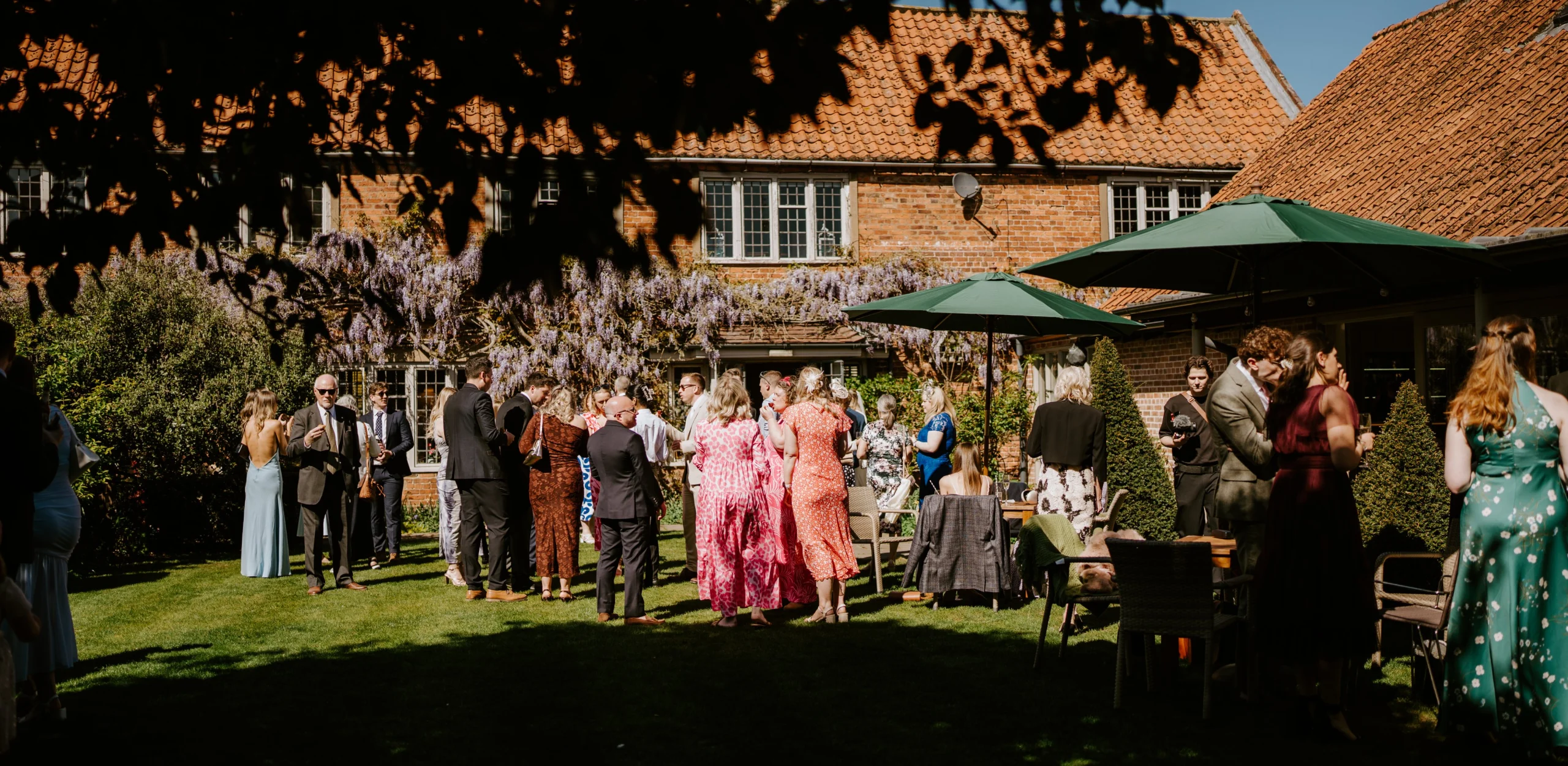 wedding guests at coach house garden doddington hall
