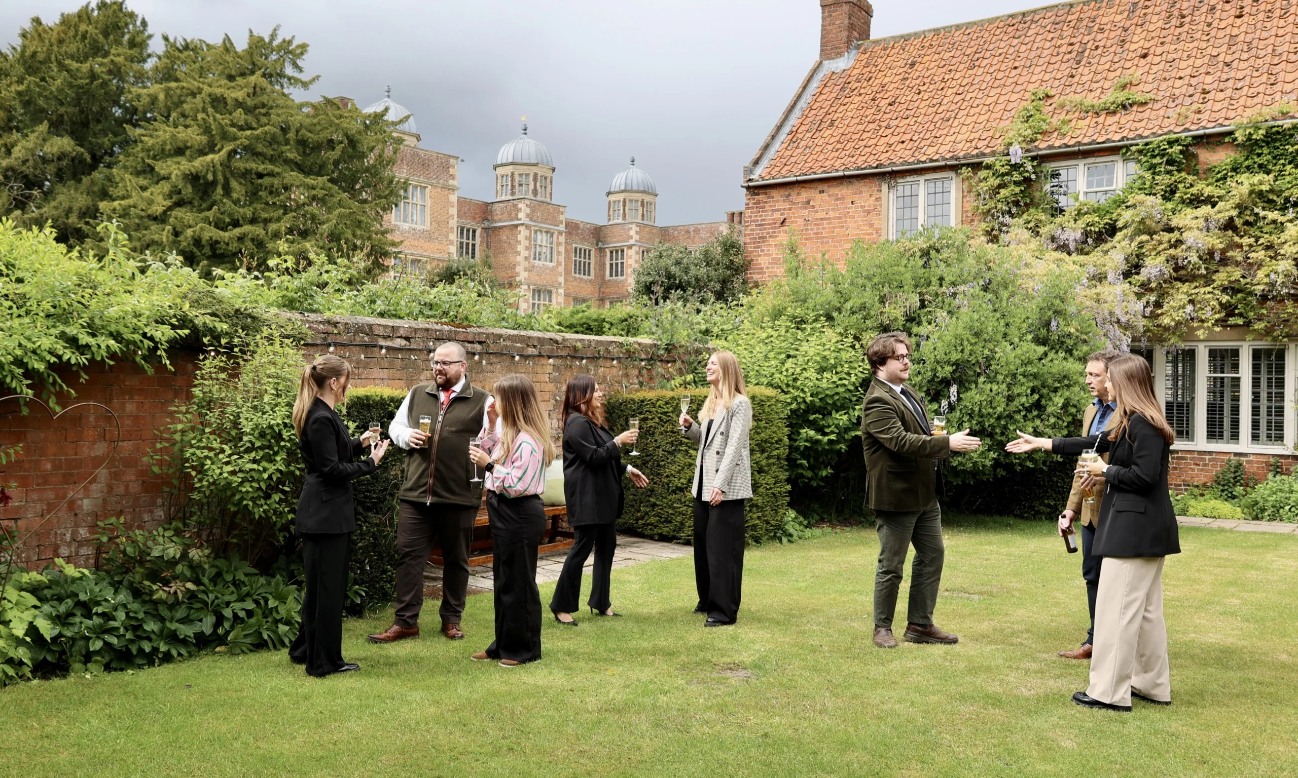 a group of professionals speaking on the lawn at doddington estate
