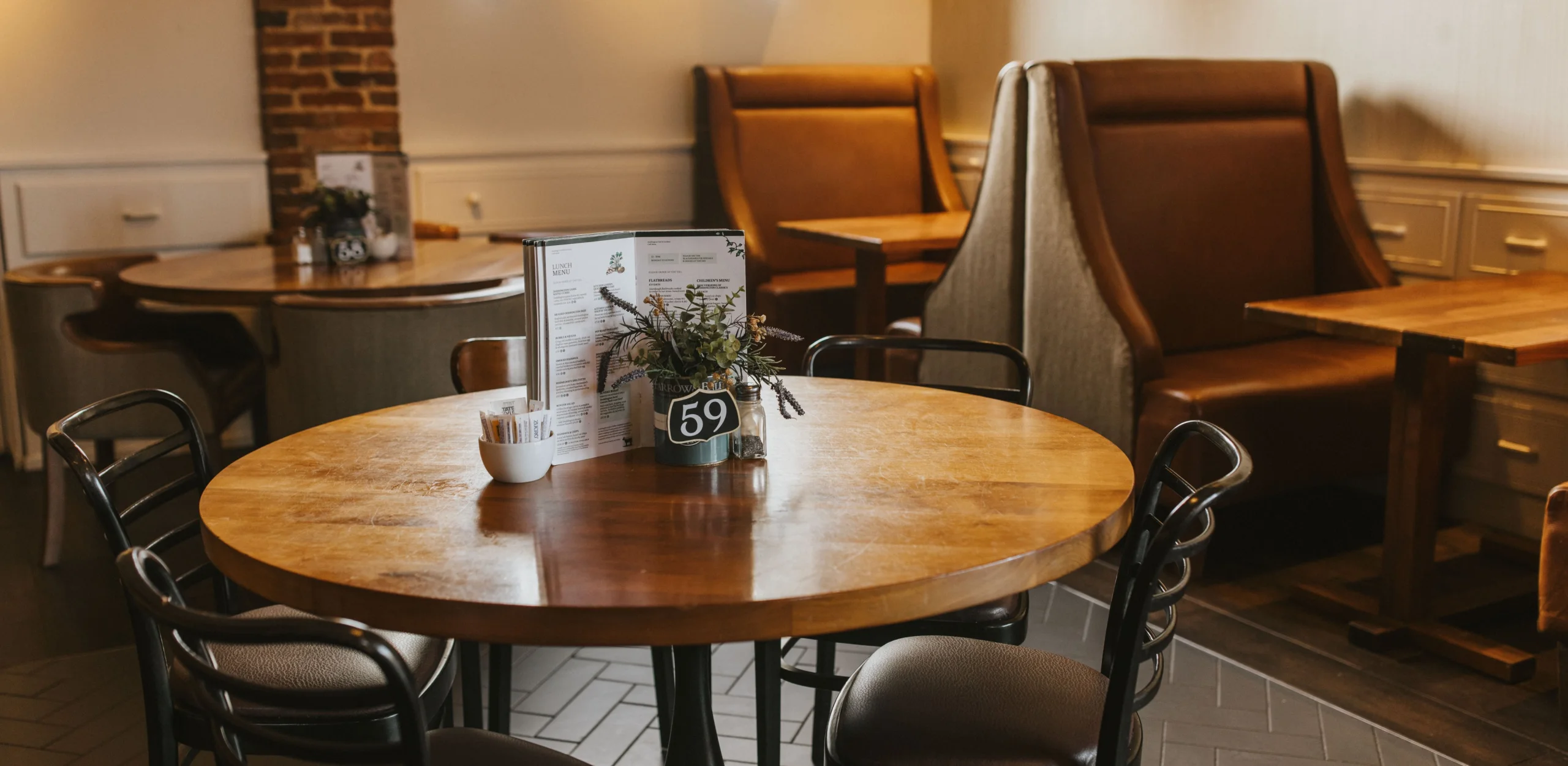wooden table with metal chairs and table number at doddington hall farm shop cafe