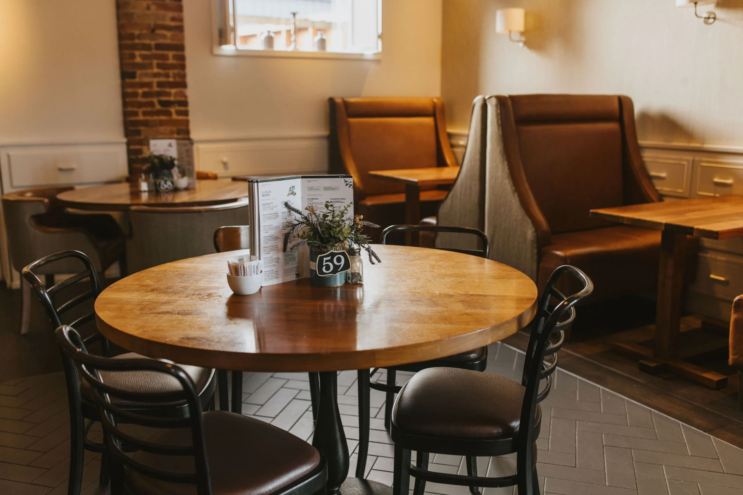 wooden table with metal chairs and table number at doddington hall farm shop cafe