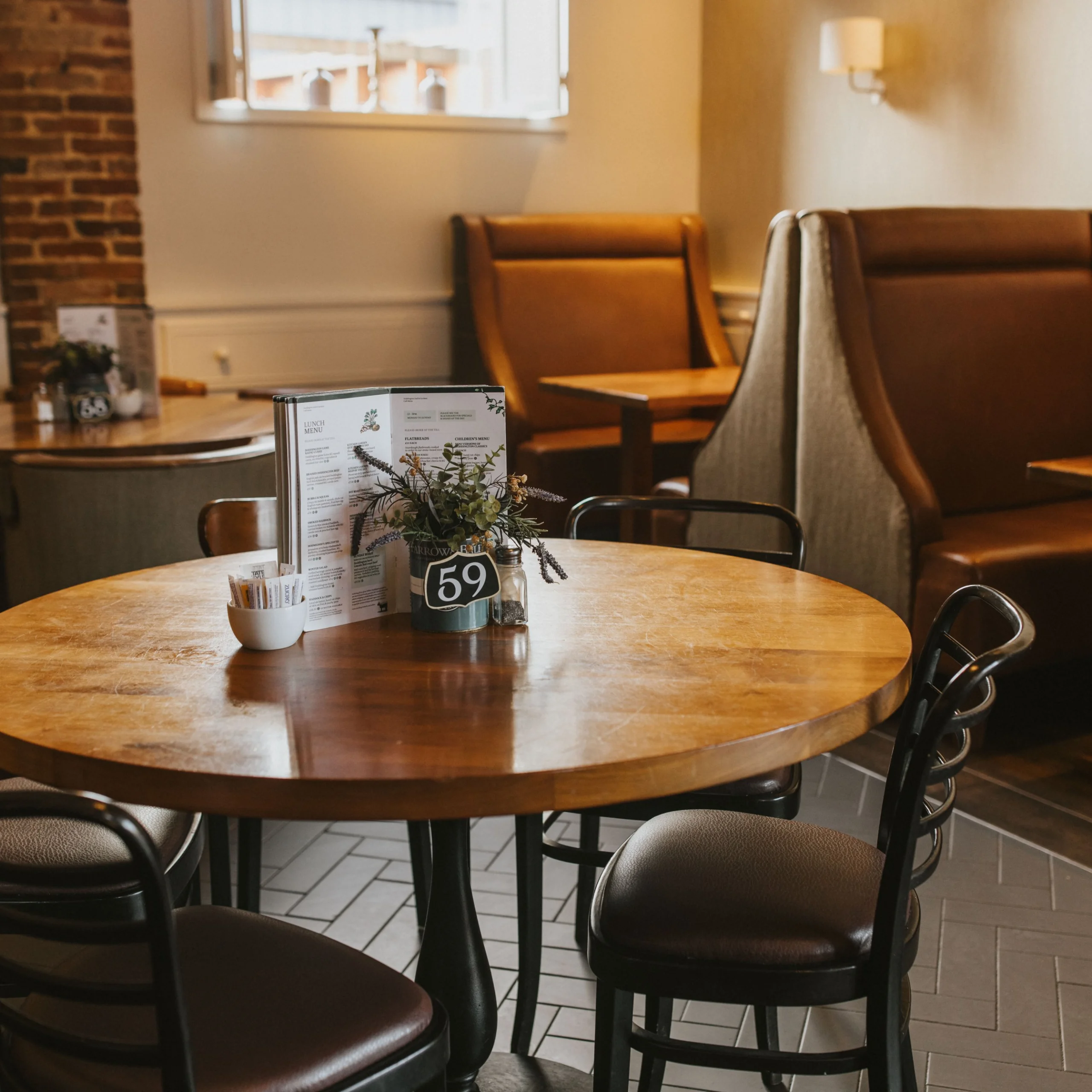 wooden table with metal chairs and table number at doddington hall farm shop cafe
