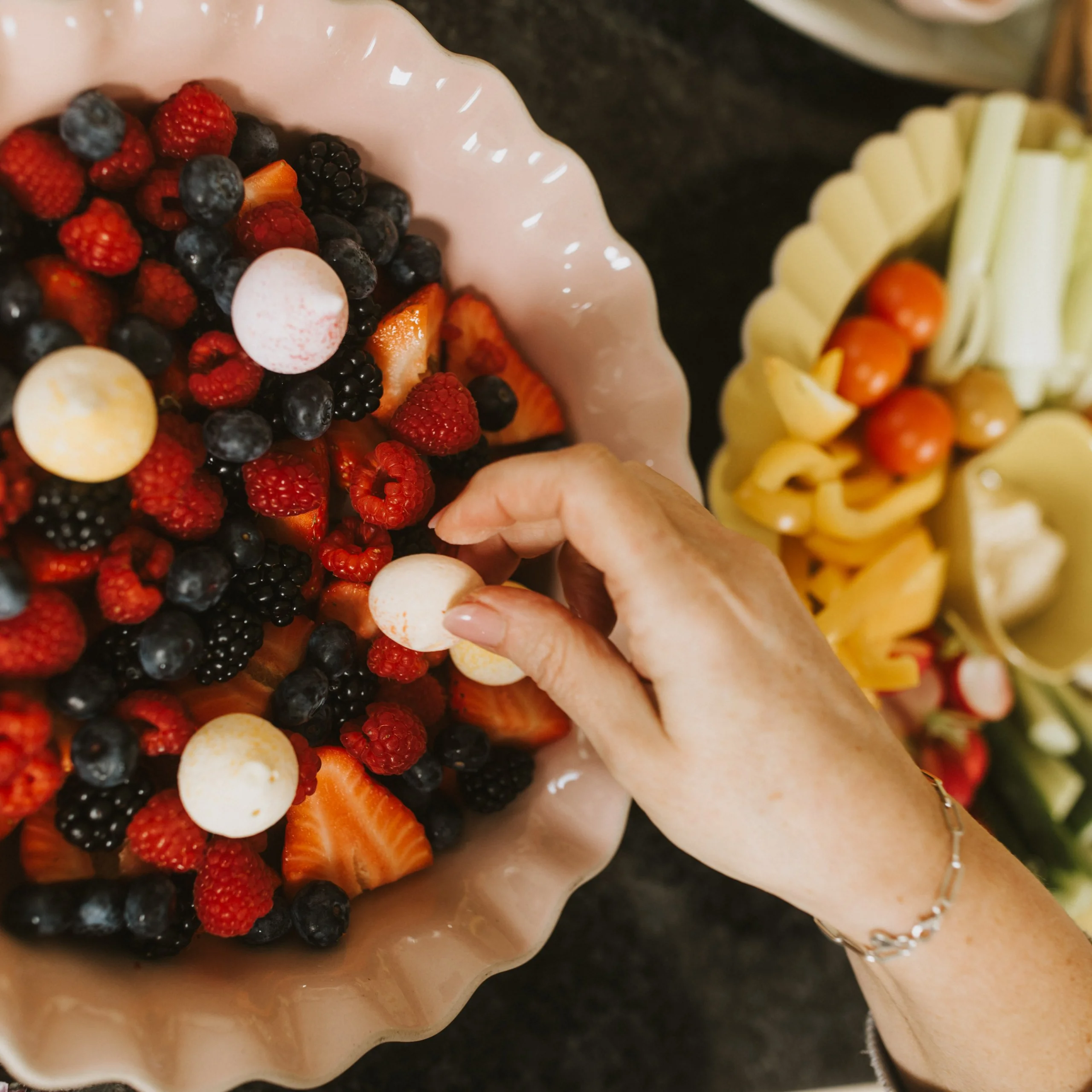 bowl of fresh berries and a ladies hand doddington hall