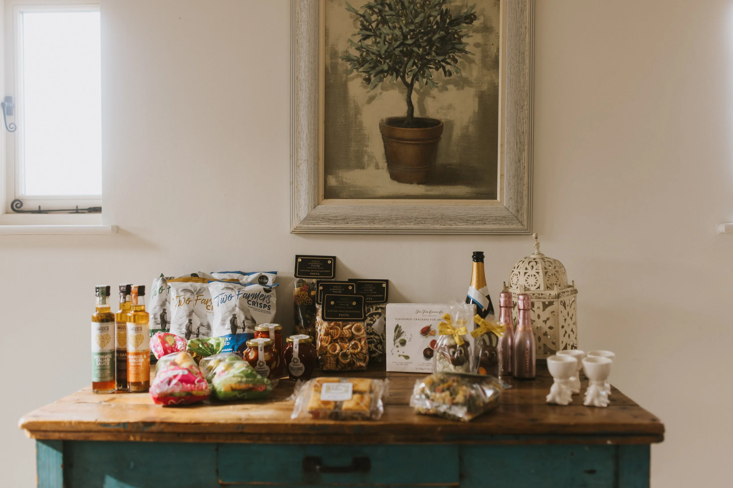 a collection of hamper foods on a wooden butchers table doddington hall