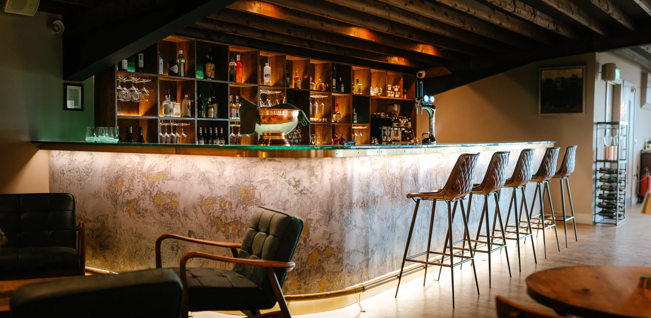 doddington grain store bar with stools and soft seating