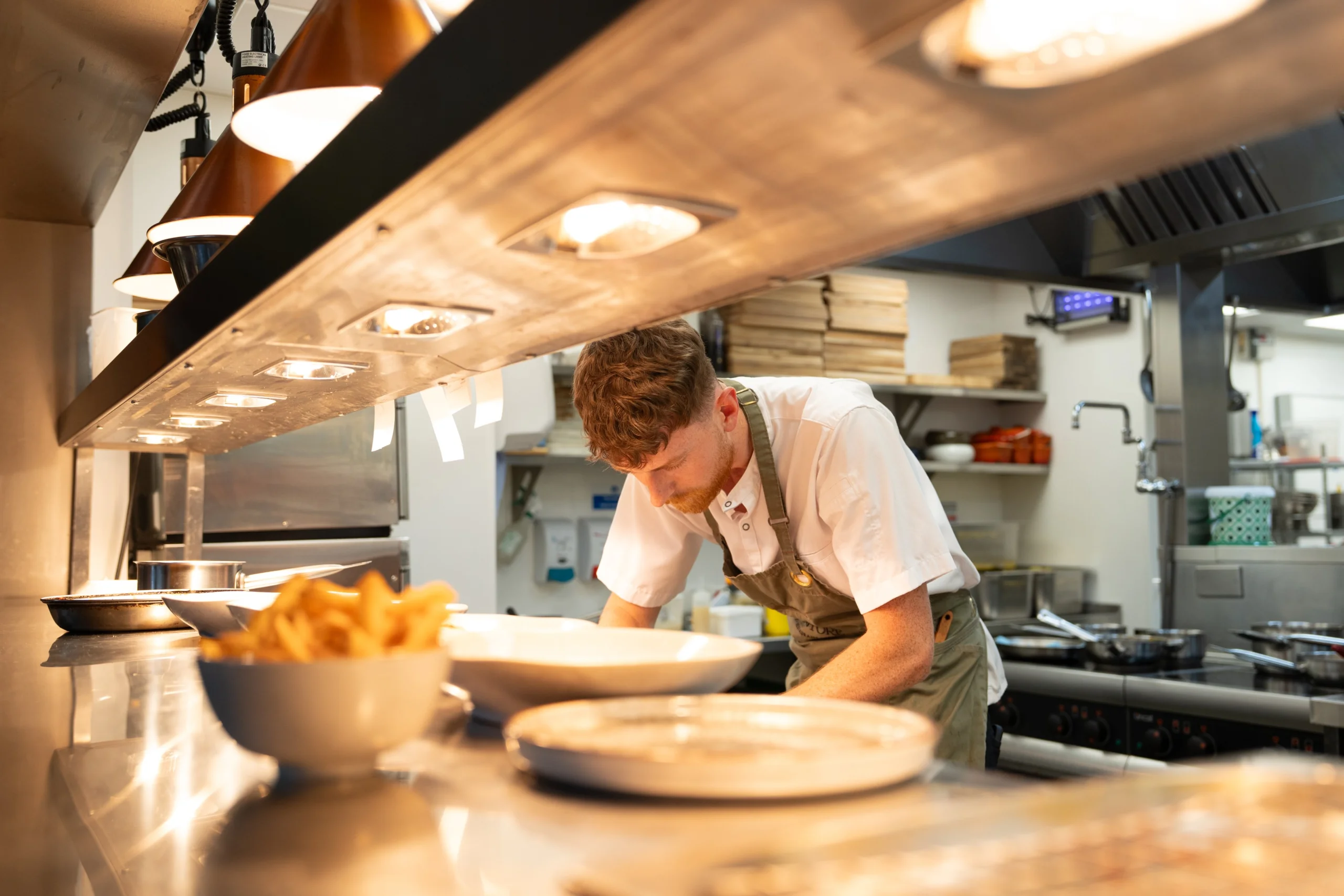 chef preparing food under lights at doddington grain store