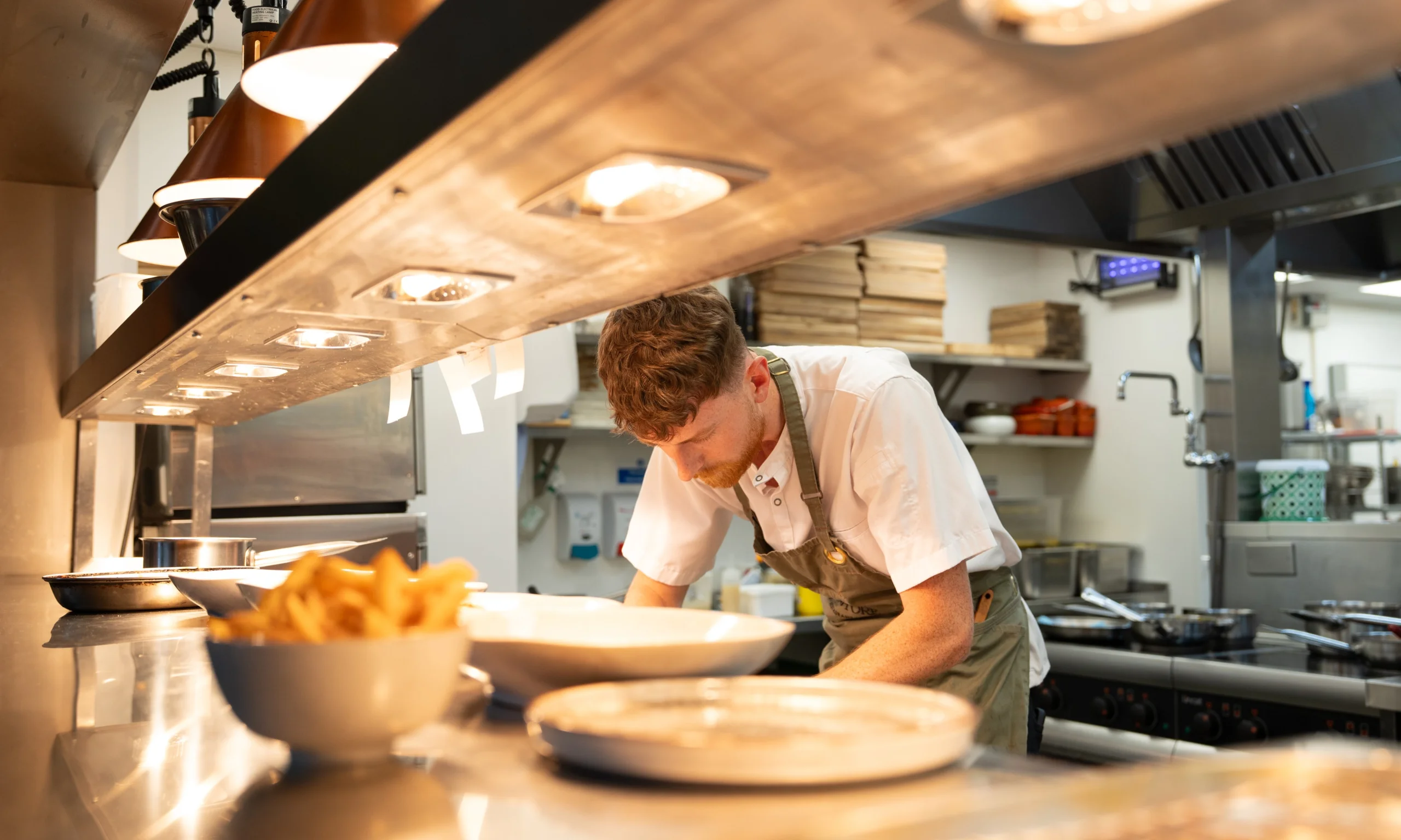 chef preparing food under lights at doddington grain store
