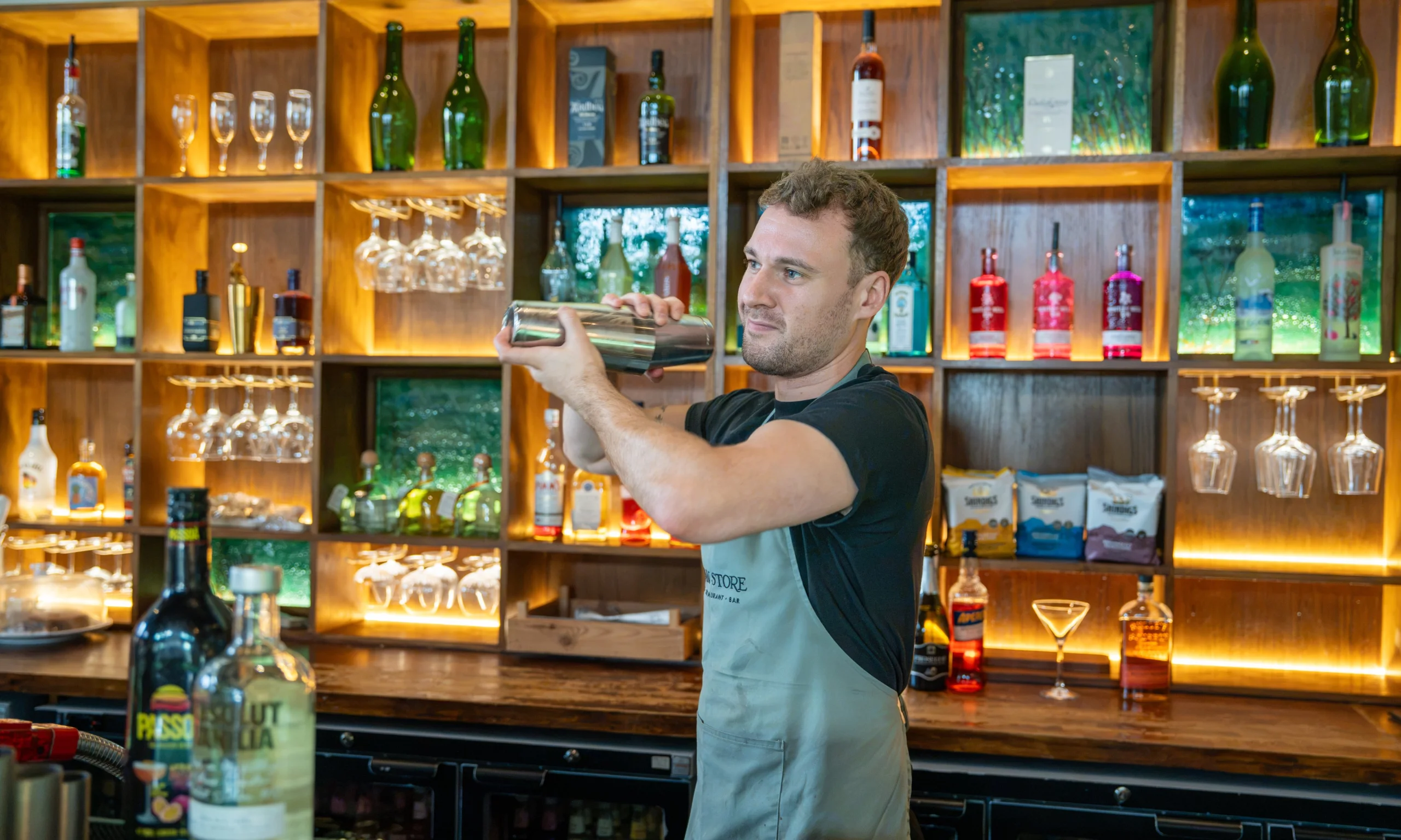 man shaking a cocktail at doddington grain store bar