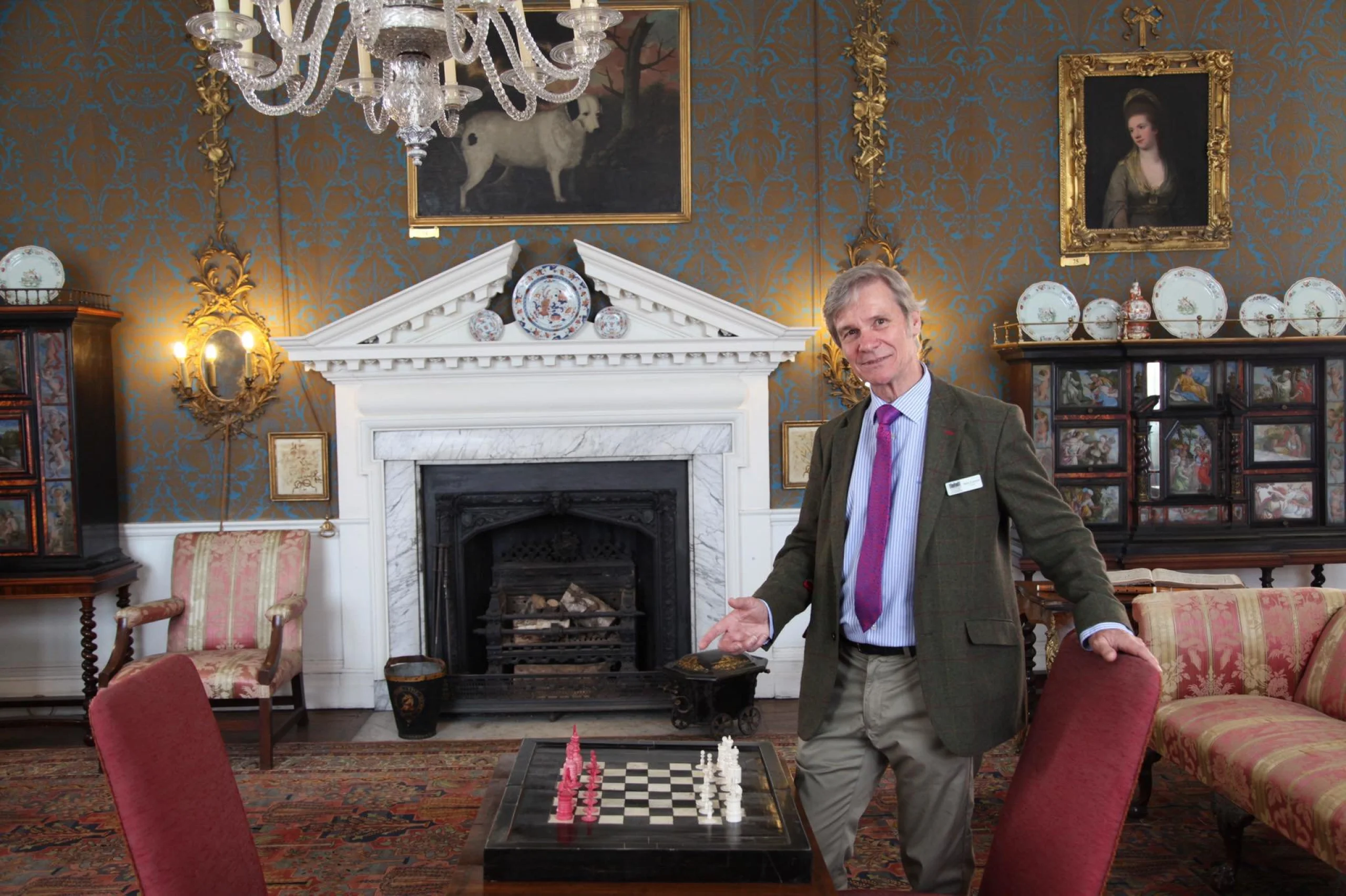 Man stood at a table with a chess set doddington hall