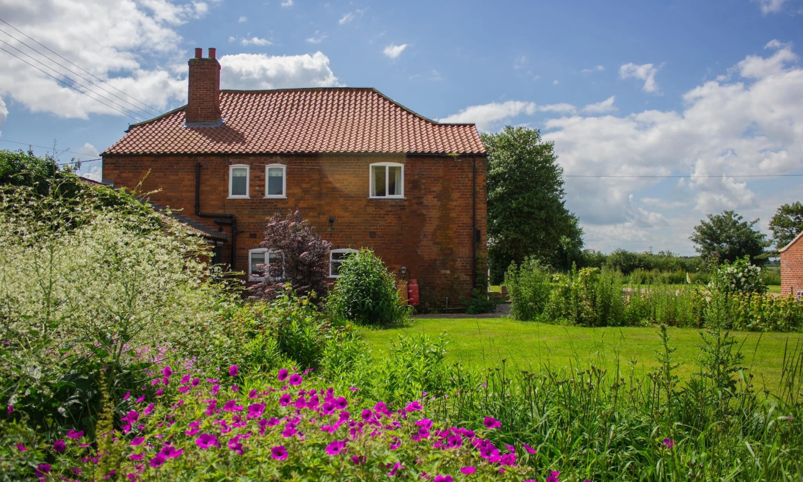 a quaint red brick cottage exterior holly farm doddington hall