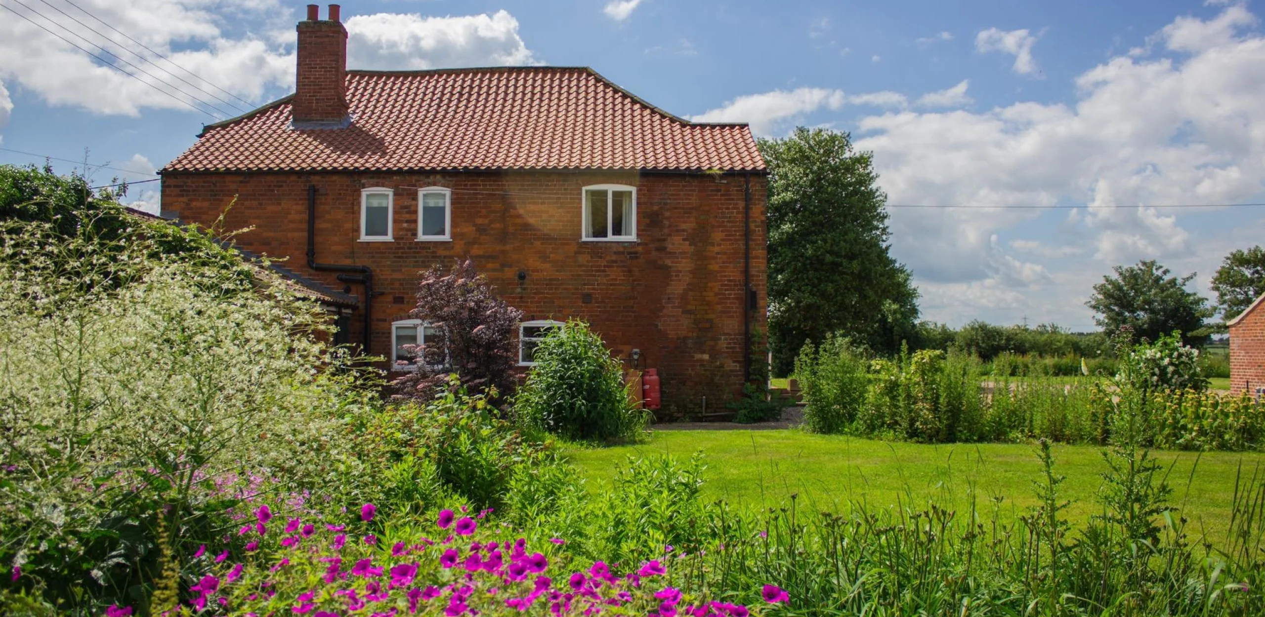a quaint red brick cottage exterior holly farm doddington hall