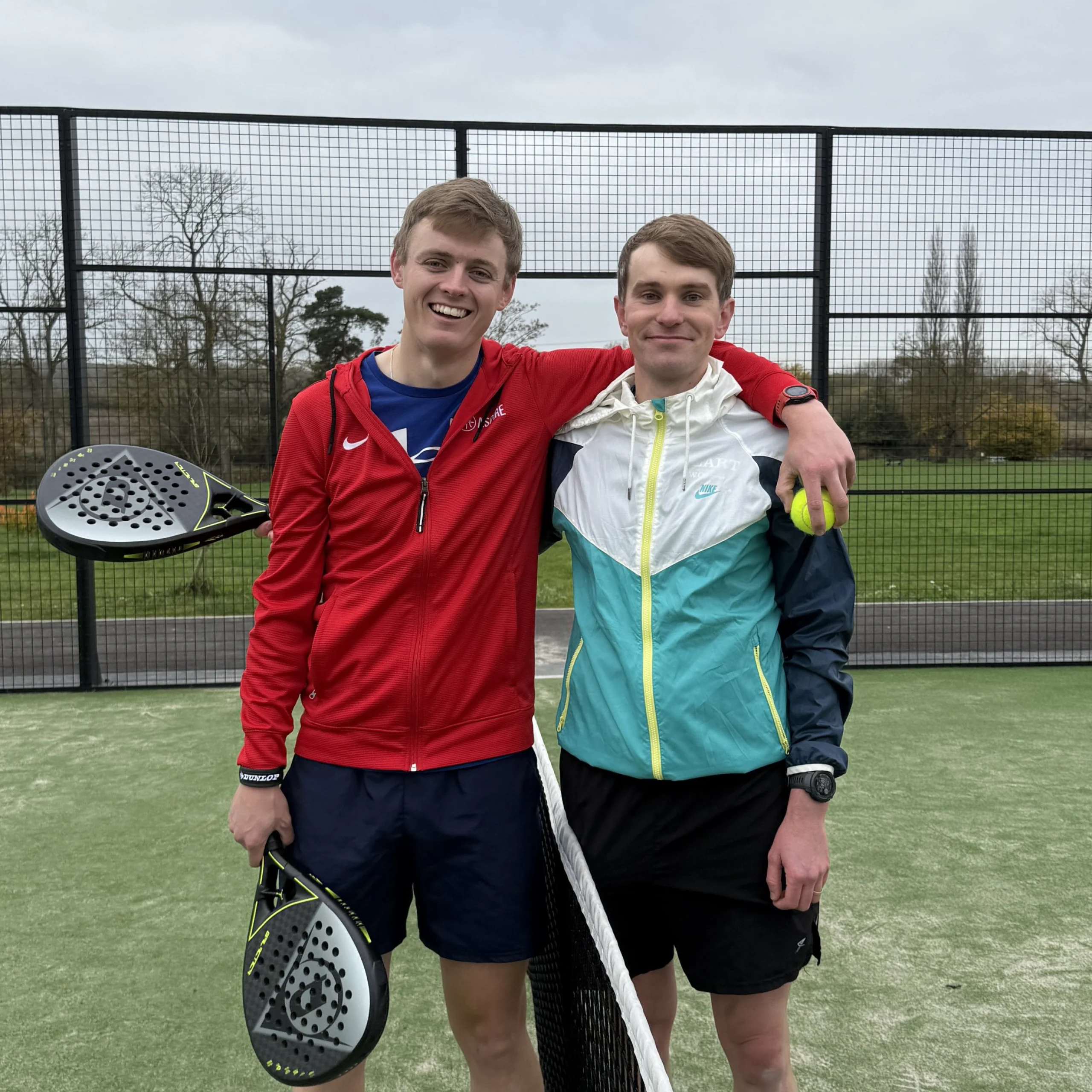 two men posing for a photo at doddington padel courts