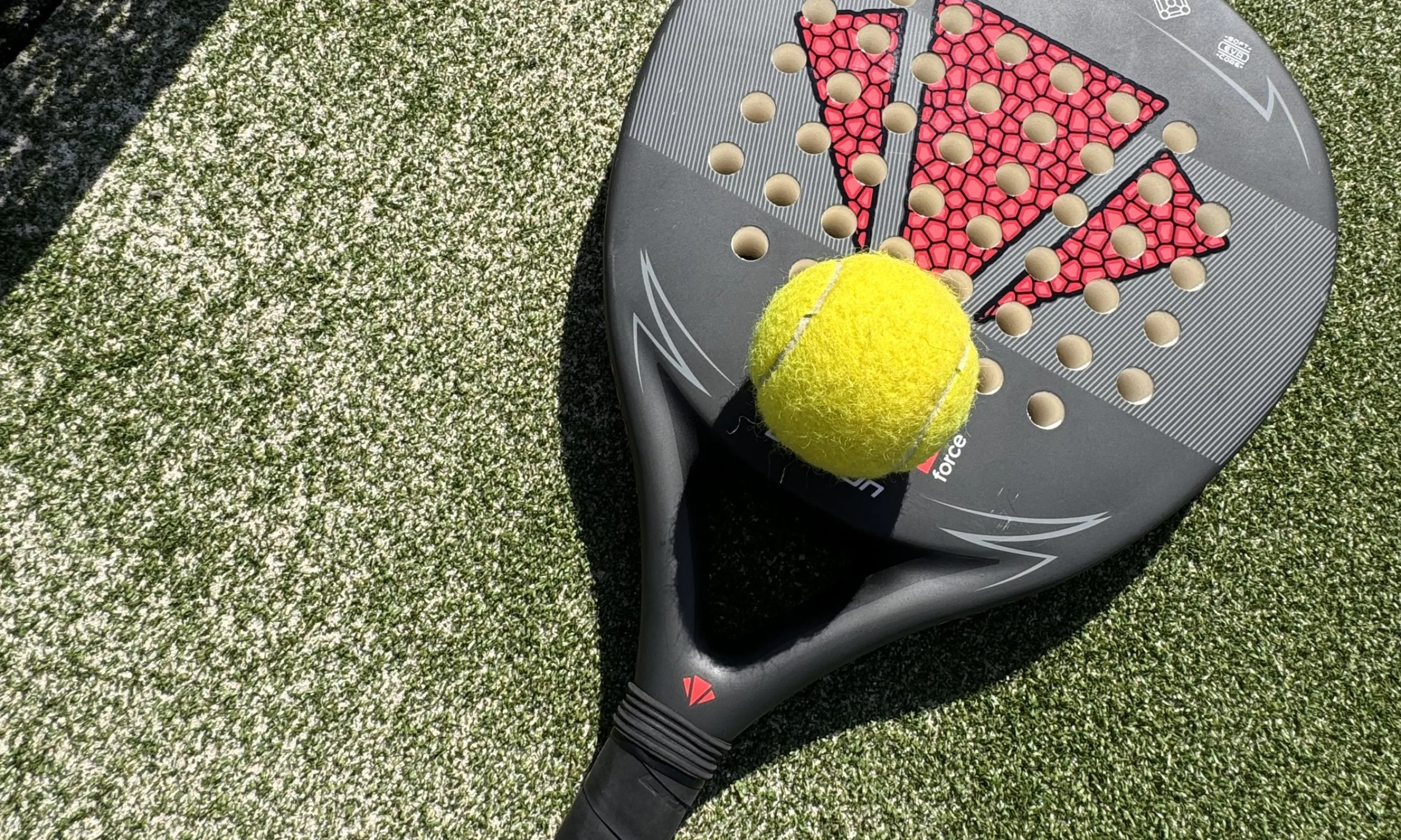 a close up of a padel racket and ball at doddington hall padel