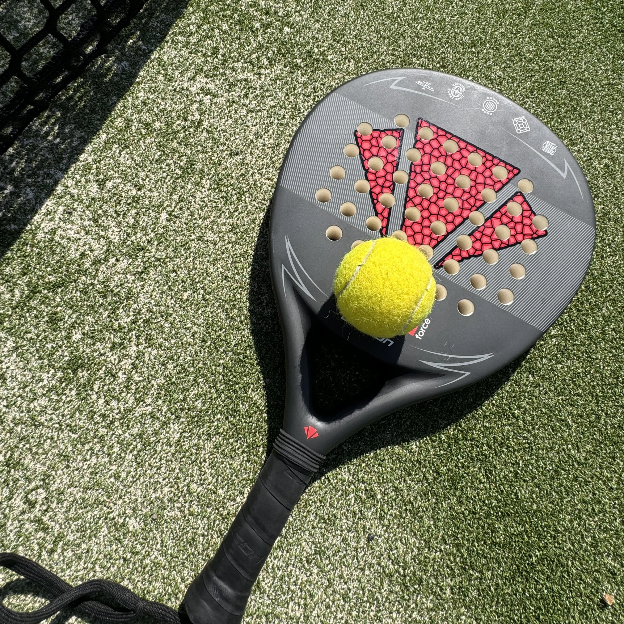 a close up of a padel racket and ball at doddington hall padel