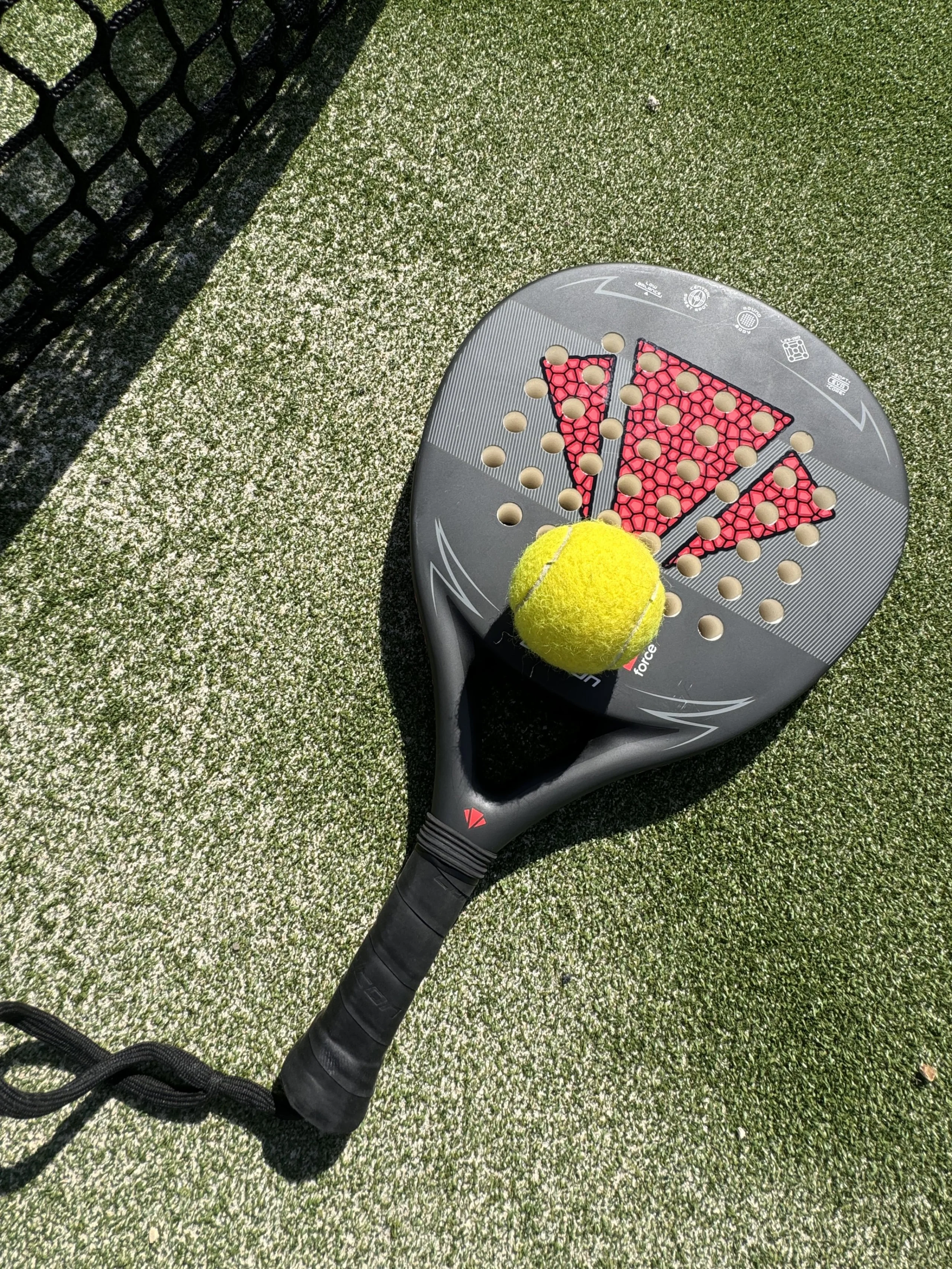 a close up of a padel racket and ball at doddington hall padel