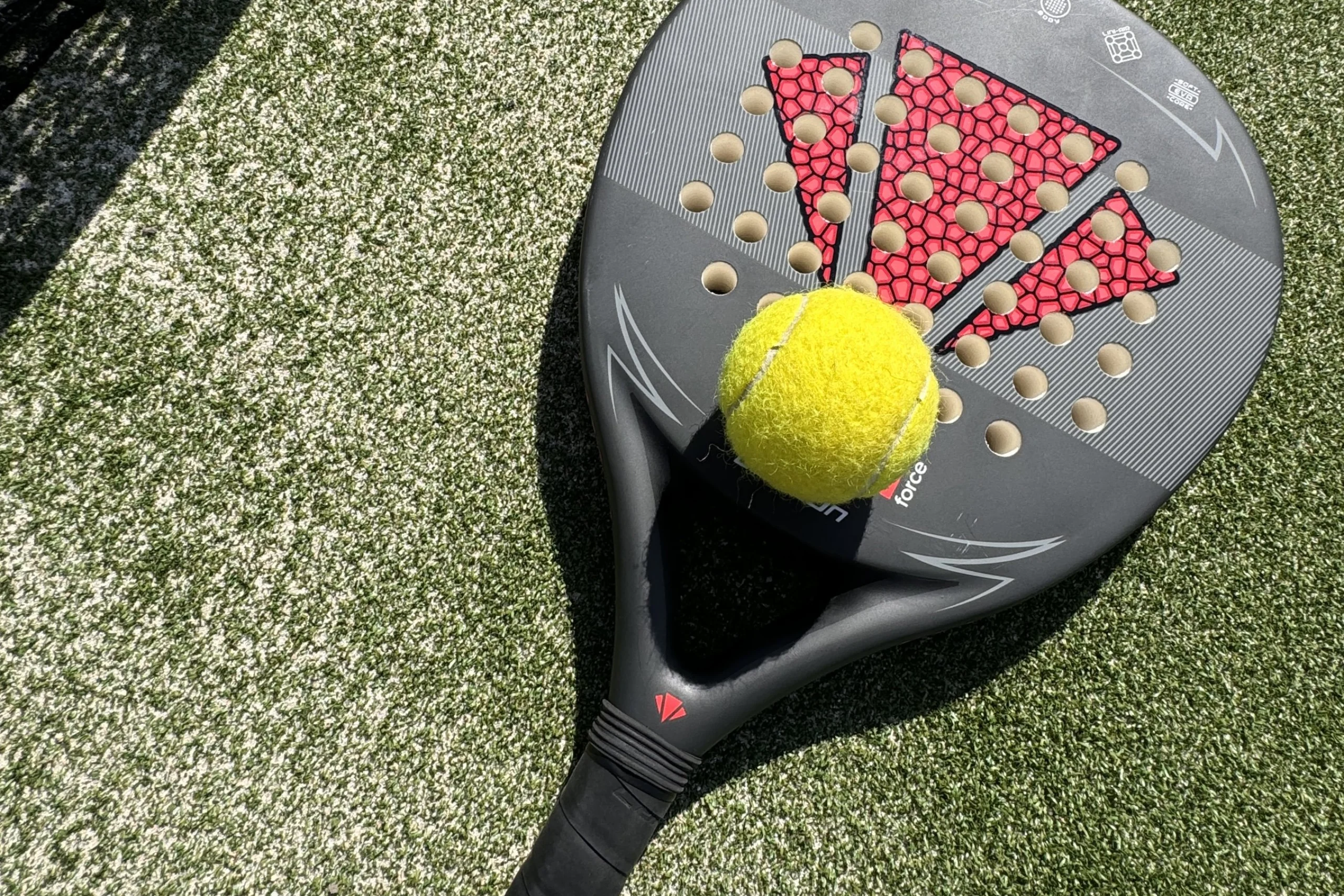 a close up of a padel racket and ball at doddington hall padel