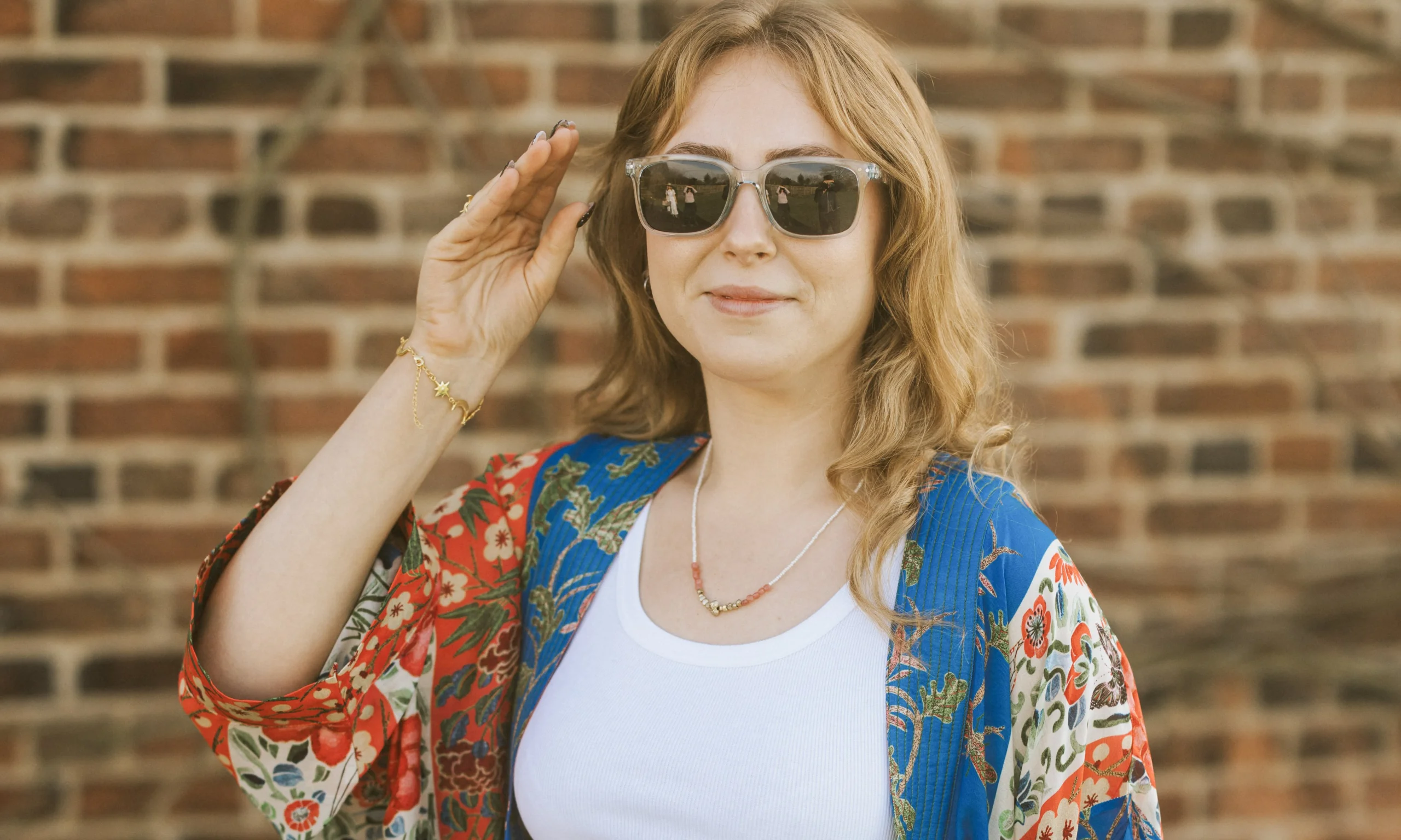 a lady in sunglasses smiling for a photo at doddington hall