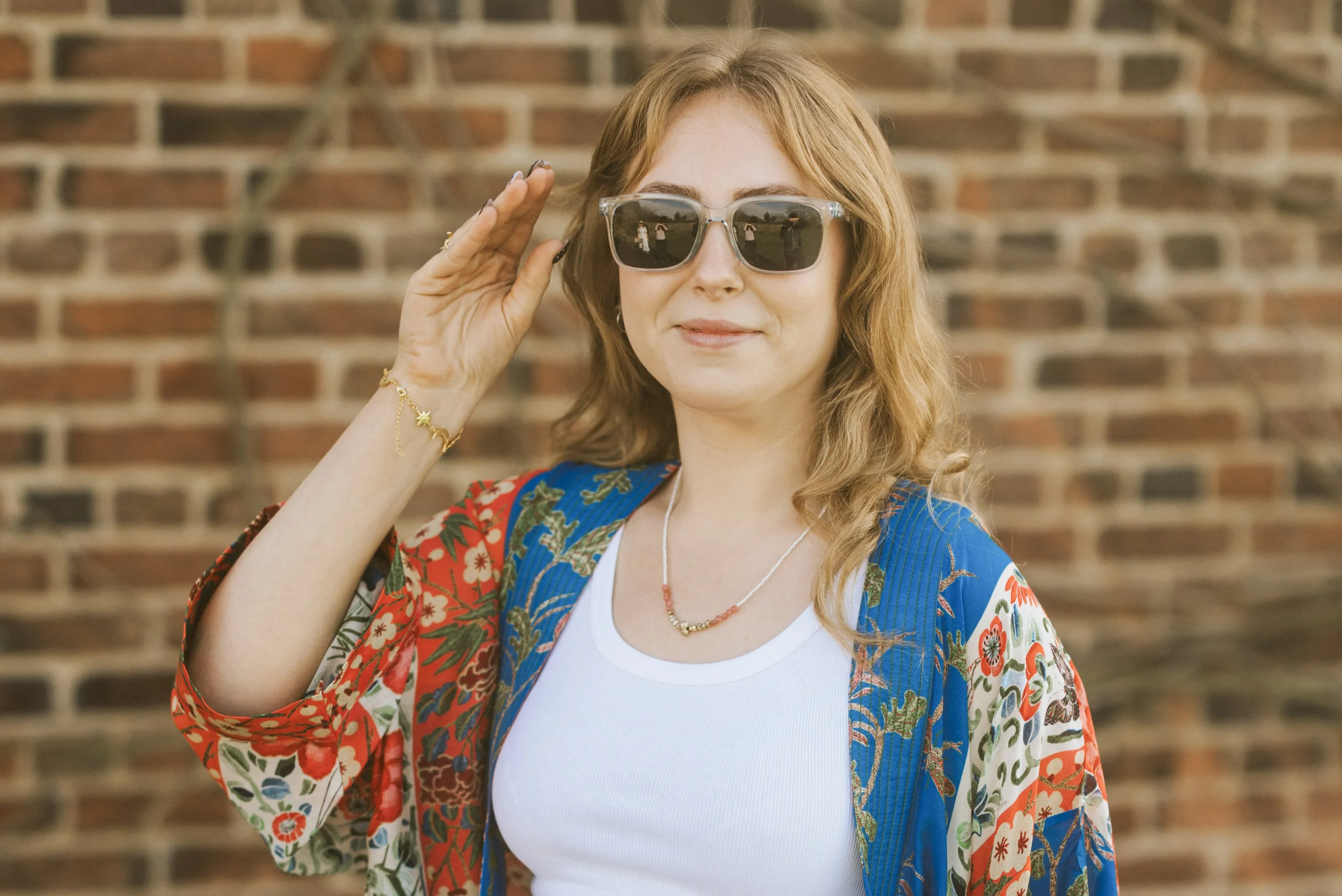 a lady in sunglasses smiling for a photo at doddington hall