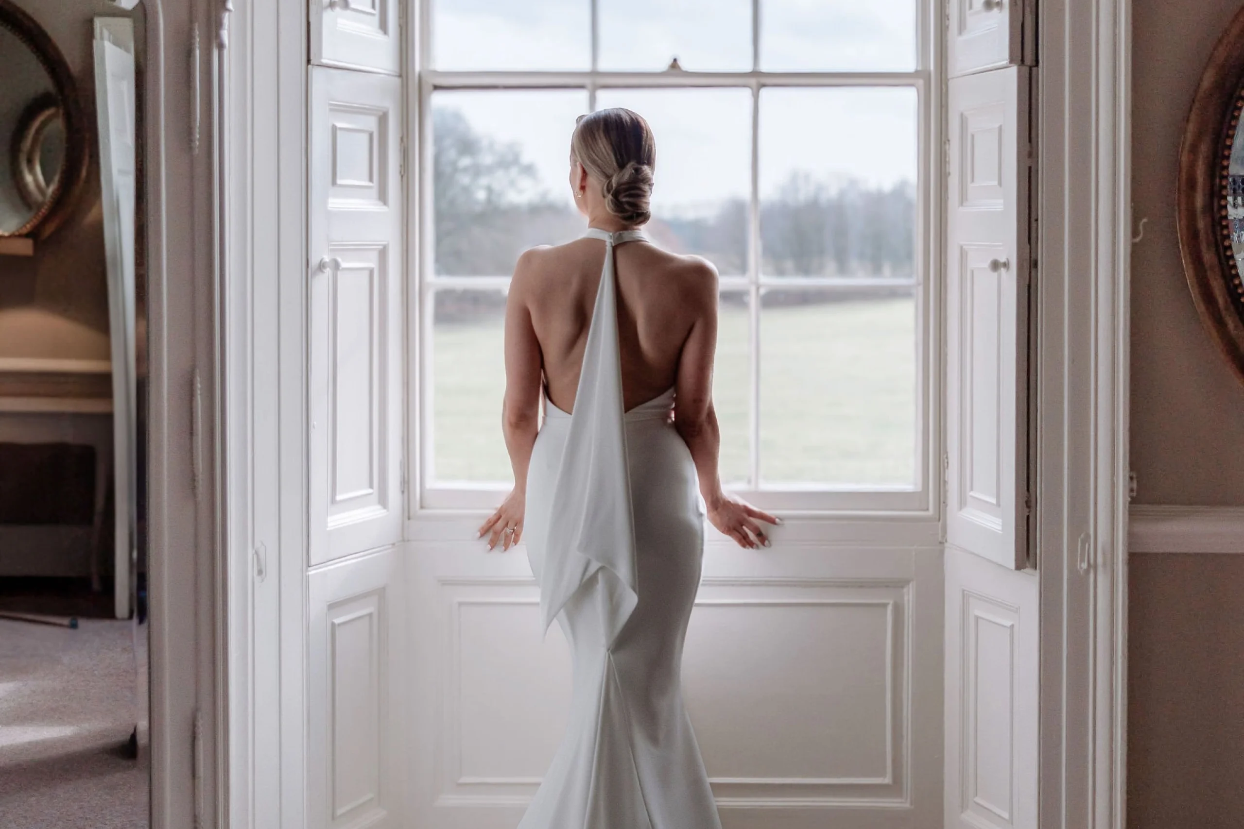 the back of a brides dress with long train elizabeth kate bridal doddington hall