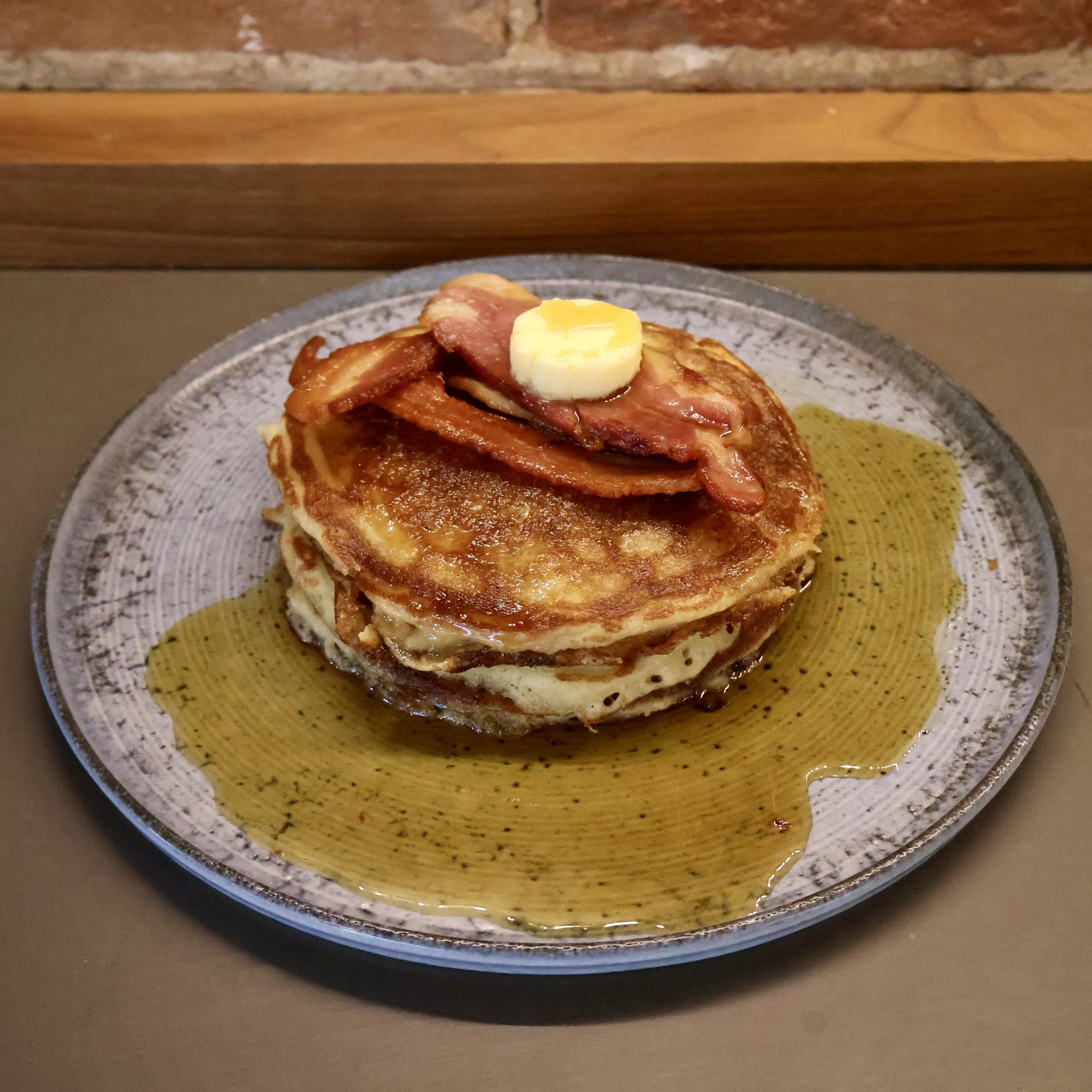 a stack of american pancakes with maple syrup and bacon doddington hall farm shop cafe