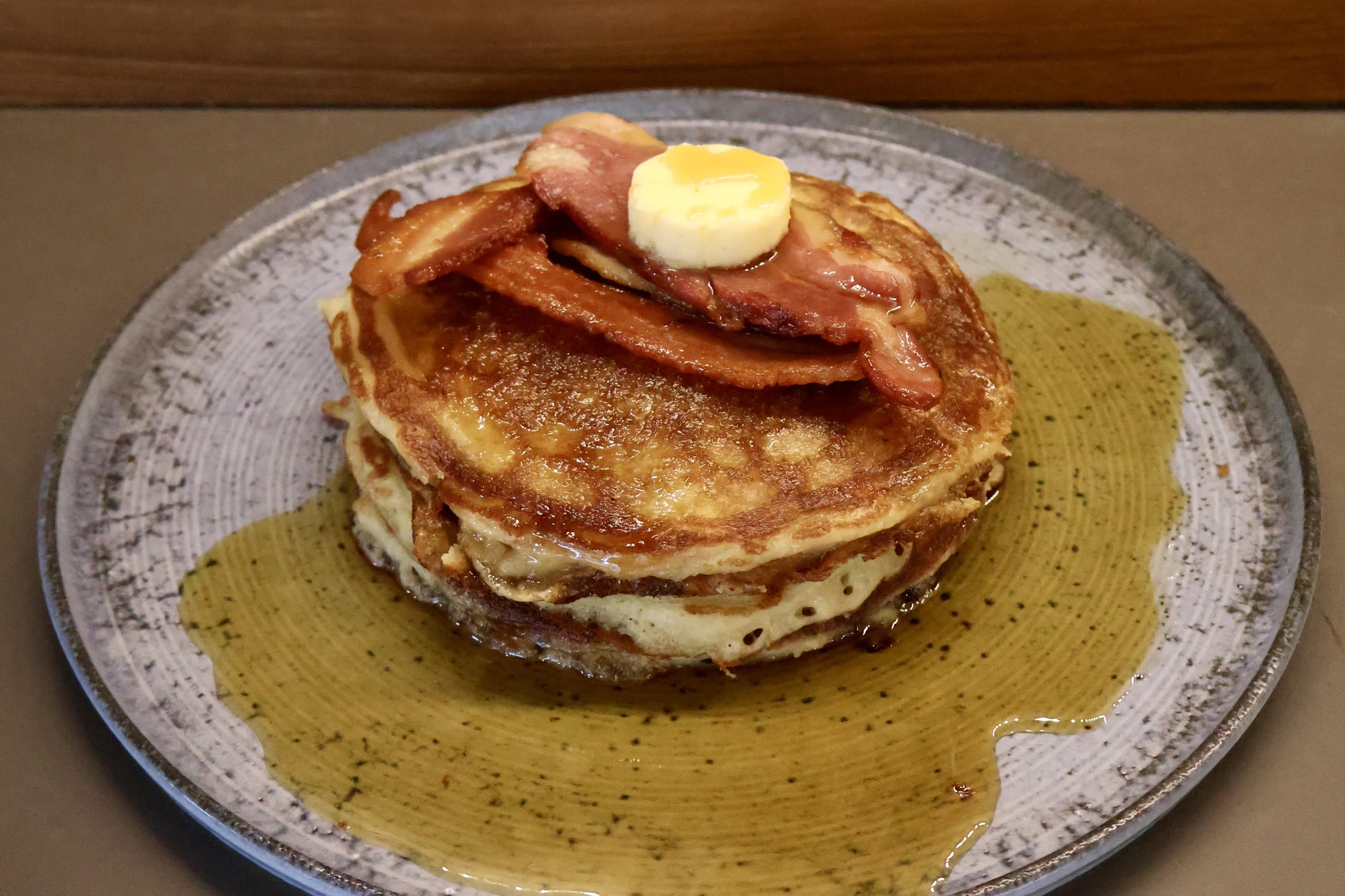 a stack of american pancakes with maple syrup and bacon doddington hall farm shop cafe
