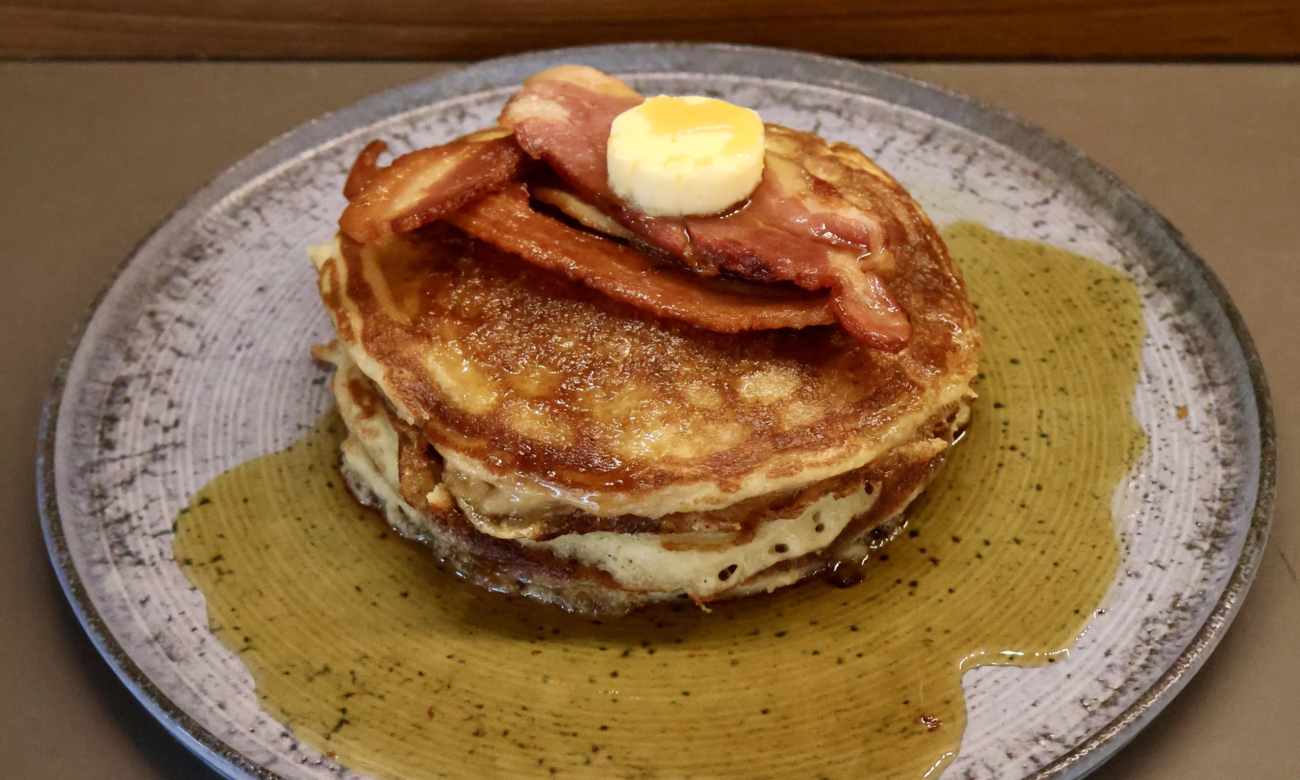 a stack of american pancakes with maple syrup and bacon doddington hall farm shop cafe