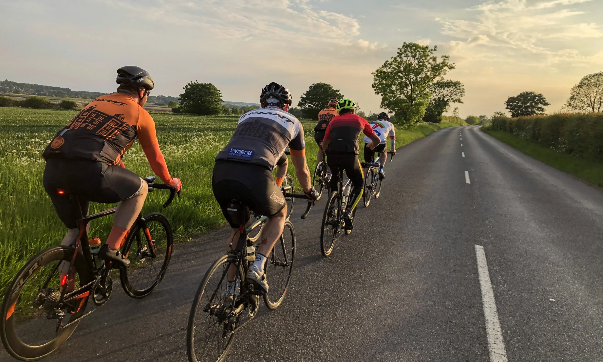a group of cyclists on the road