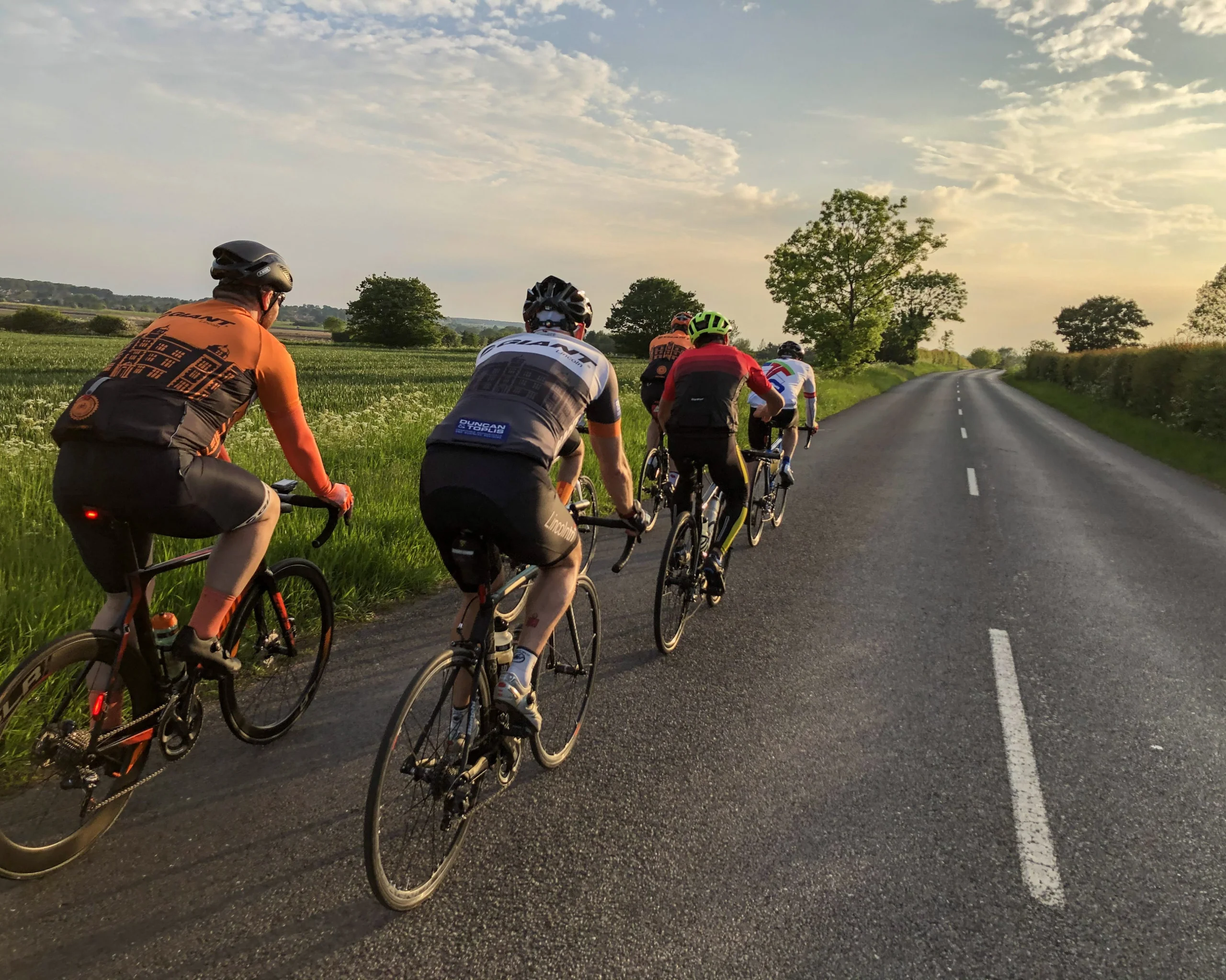 a group of cyclists on the road