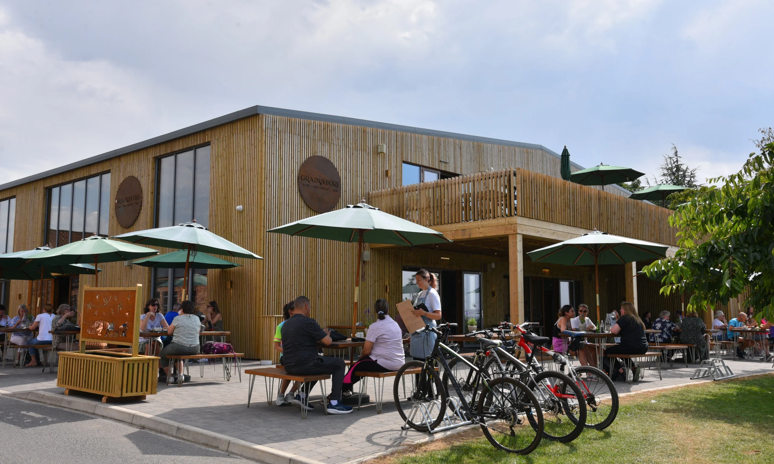 outdoor tables and chairs with umbrellas at doddington grain store