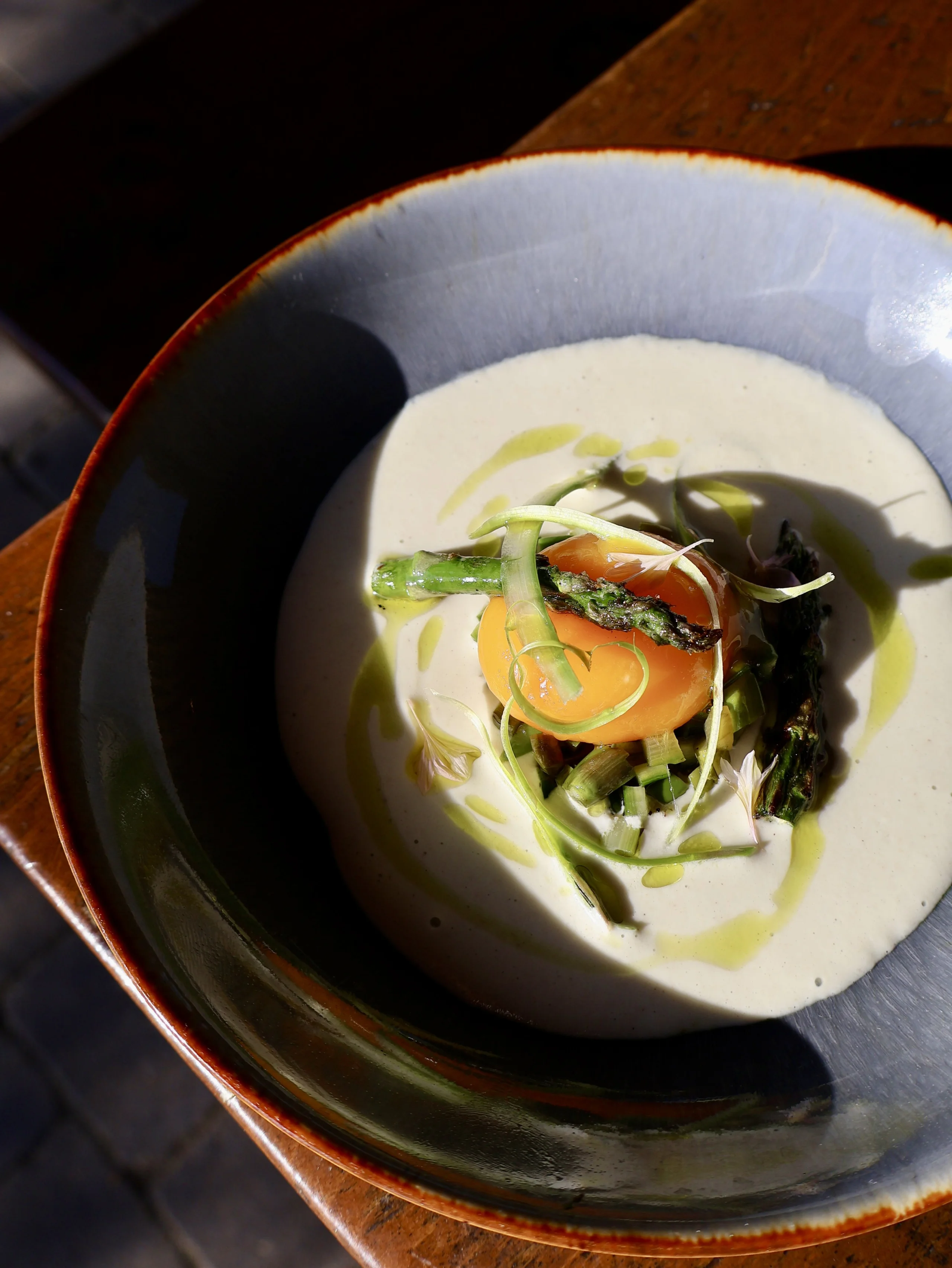 a bowl with creamy asparagus at grain store supper club doddington hall