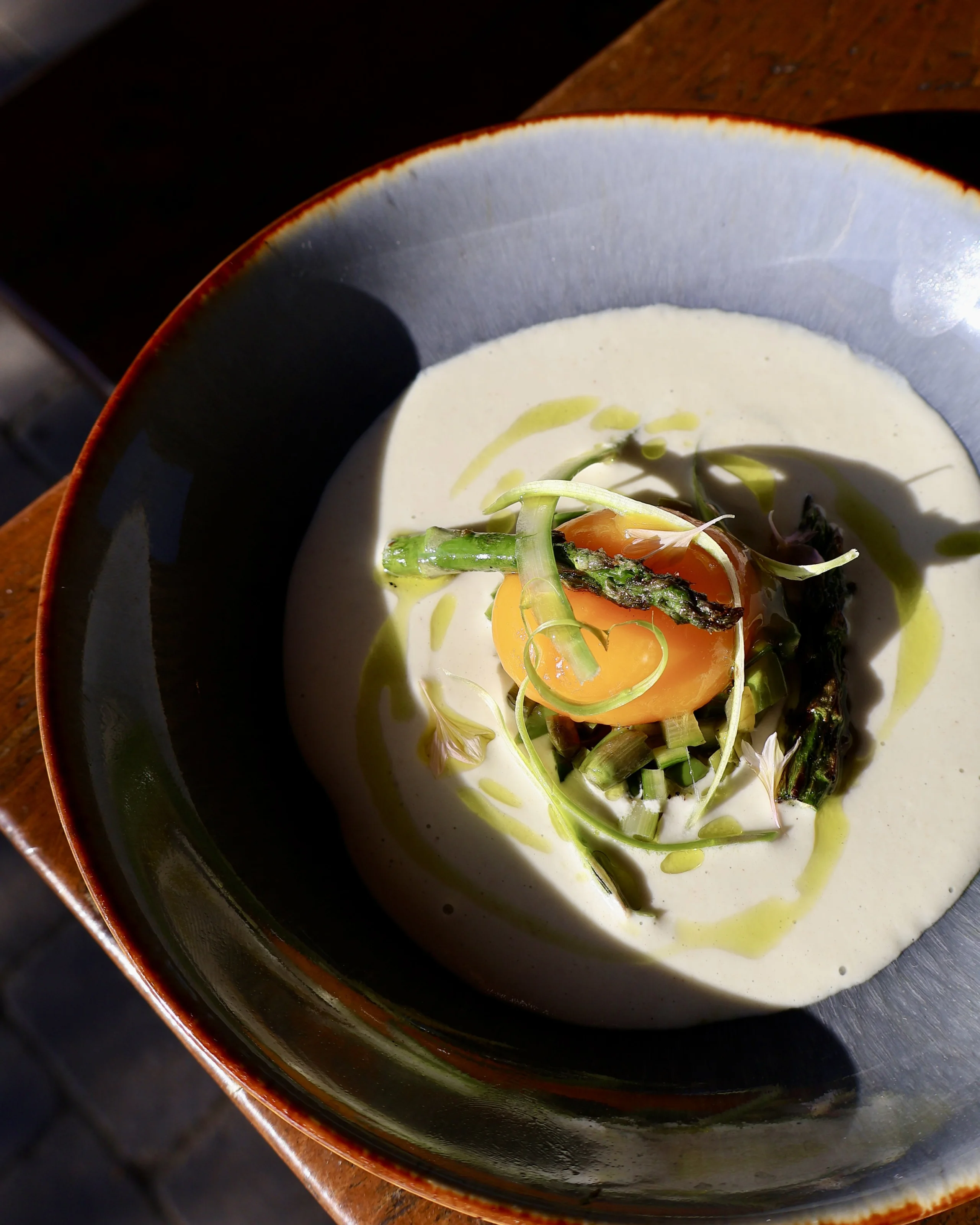 a bowl with creamy asparagus at grain store supper club doddington hall