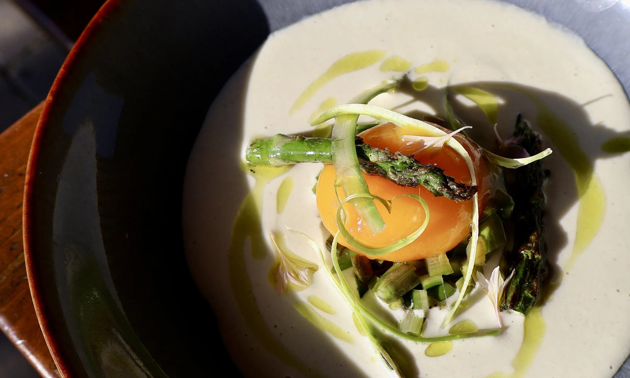 a bowl with creamy asparagus at grain store supper club doddington hall