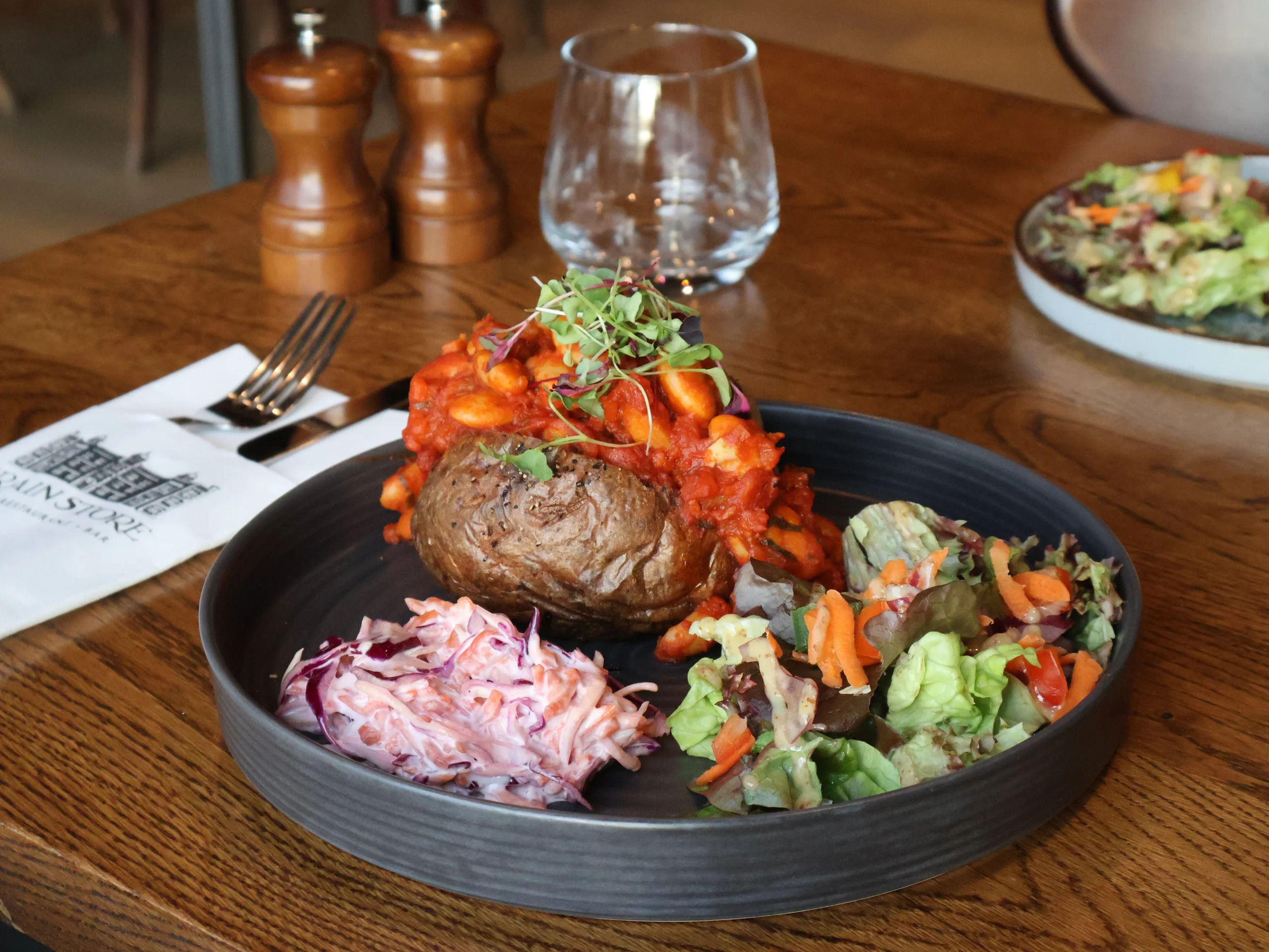 a plate with a filled jacket potato with salad at doddington farm shop cafe