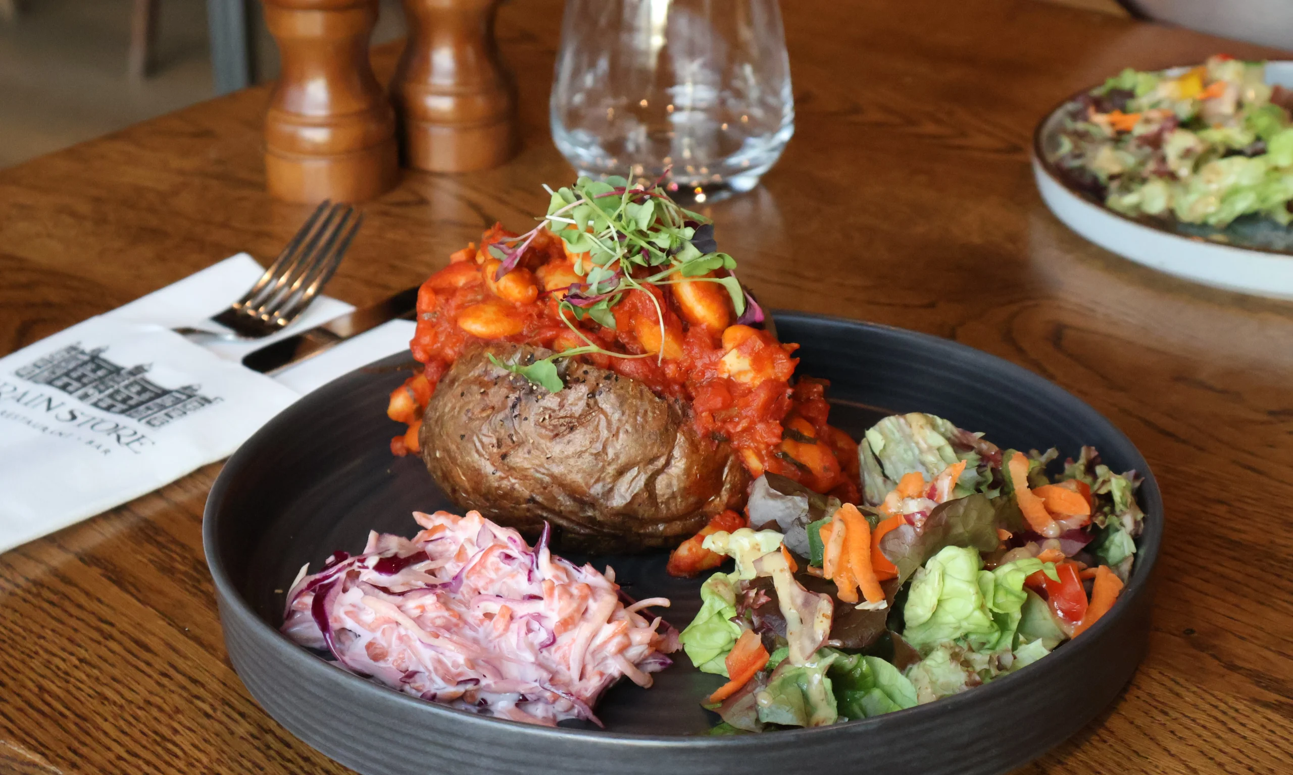 a plate with a filled jacket potato with salad at doddington farm shop cafe