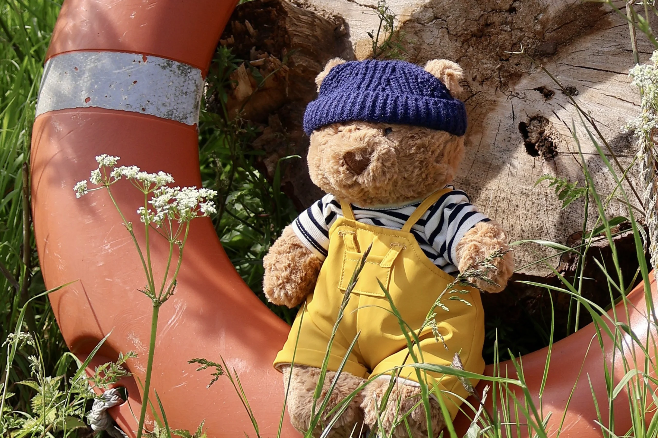 a soft toy jellycat bear with a blue hat