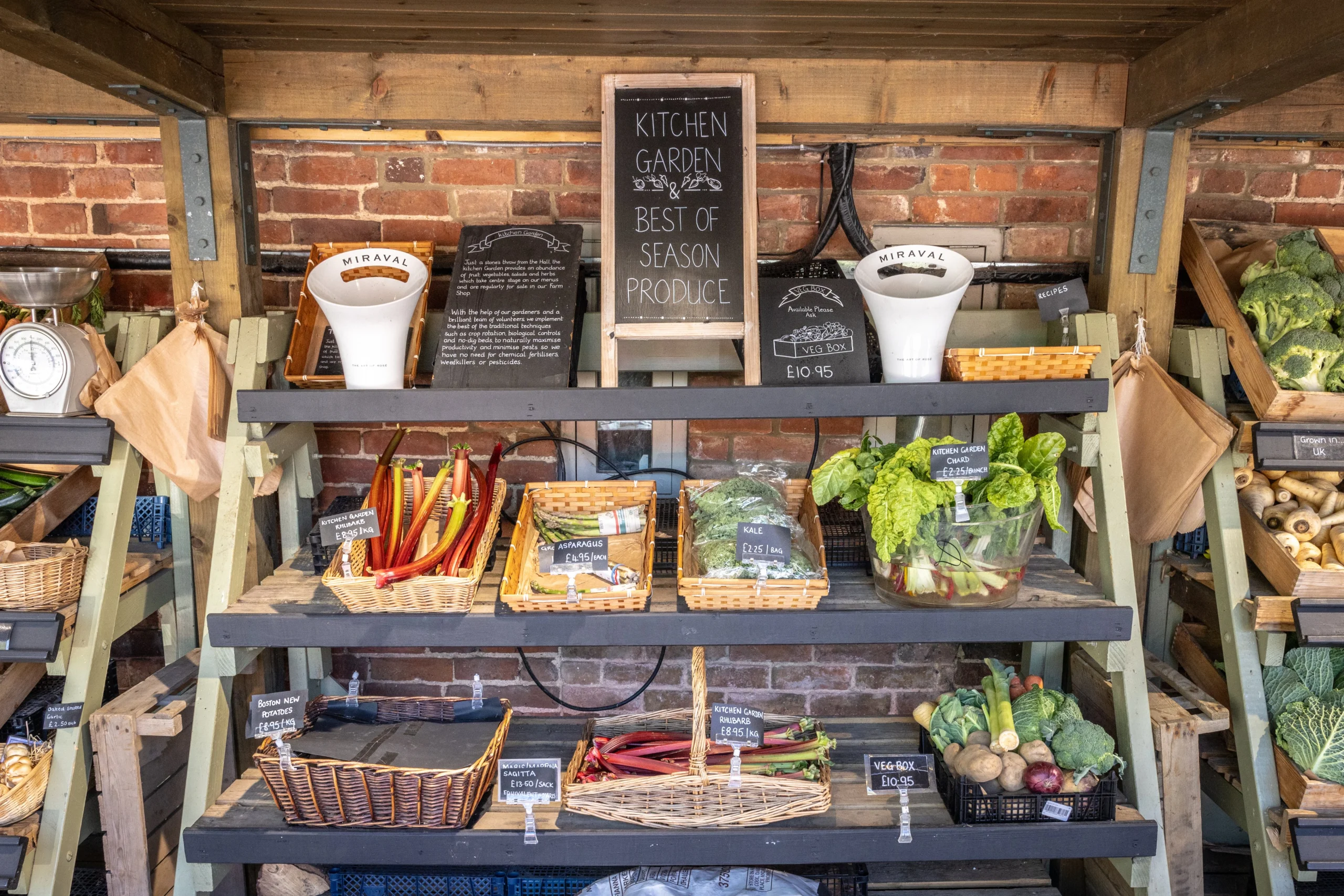 kitchen garden produce on wooden shelves at doddington hall farm shop
