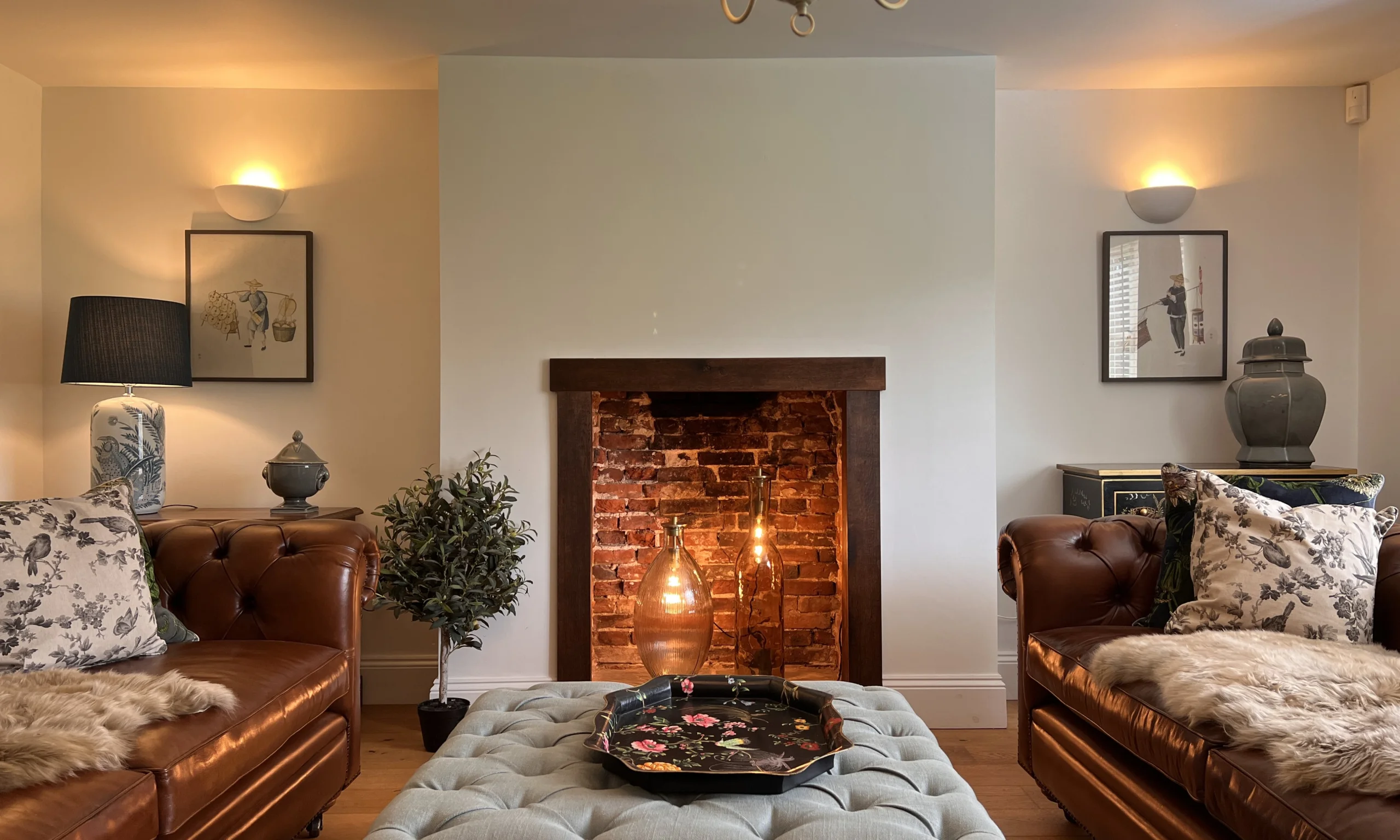 a living room with sofas and a fireplace at grange farm doddington hall