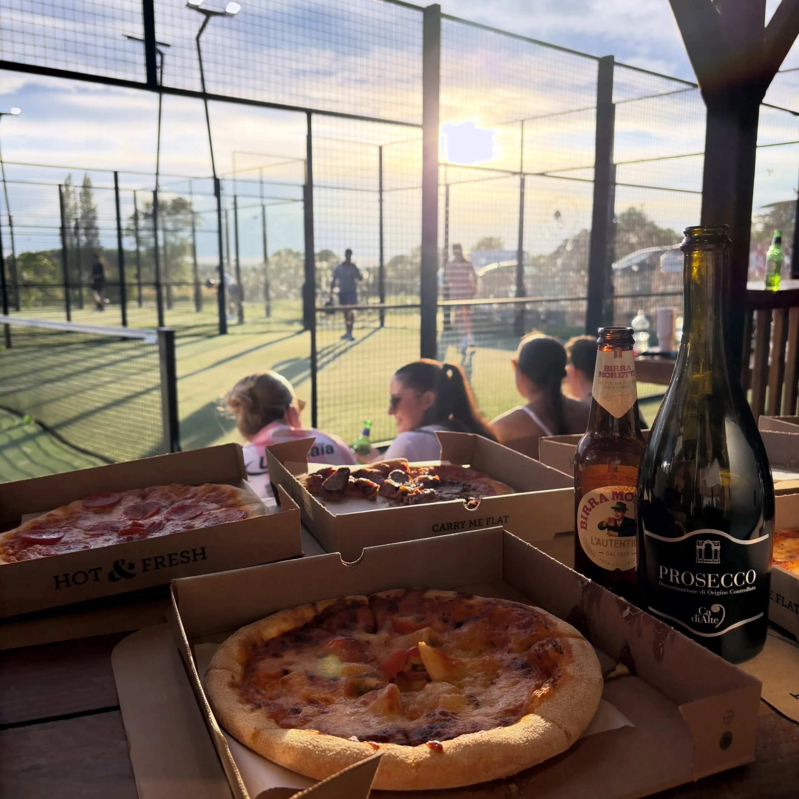 a padel social at doddington hall with pizza and prosecco