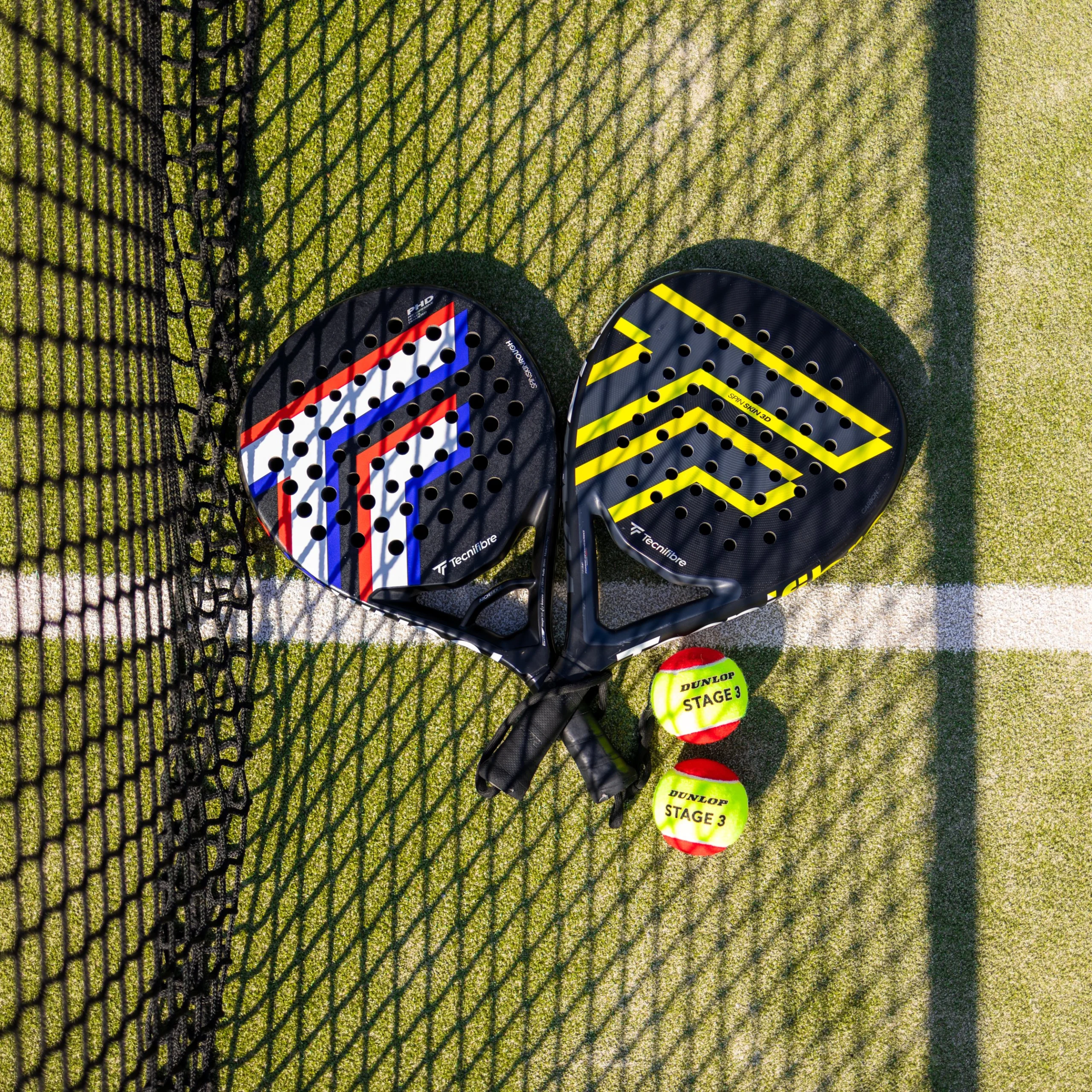 a close up of two padel rackets and balls next to a padel net at doddington hall