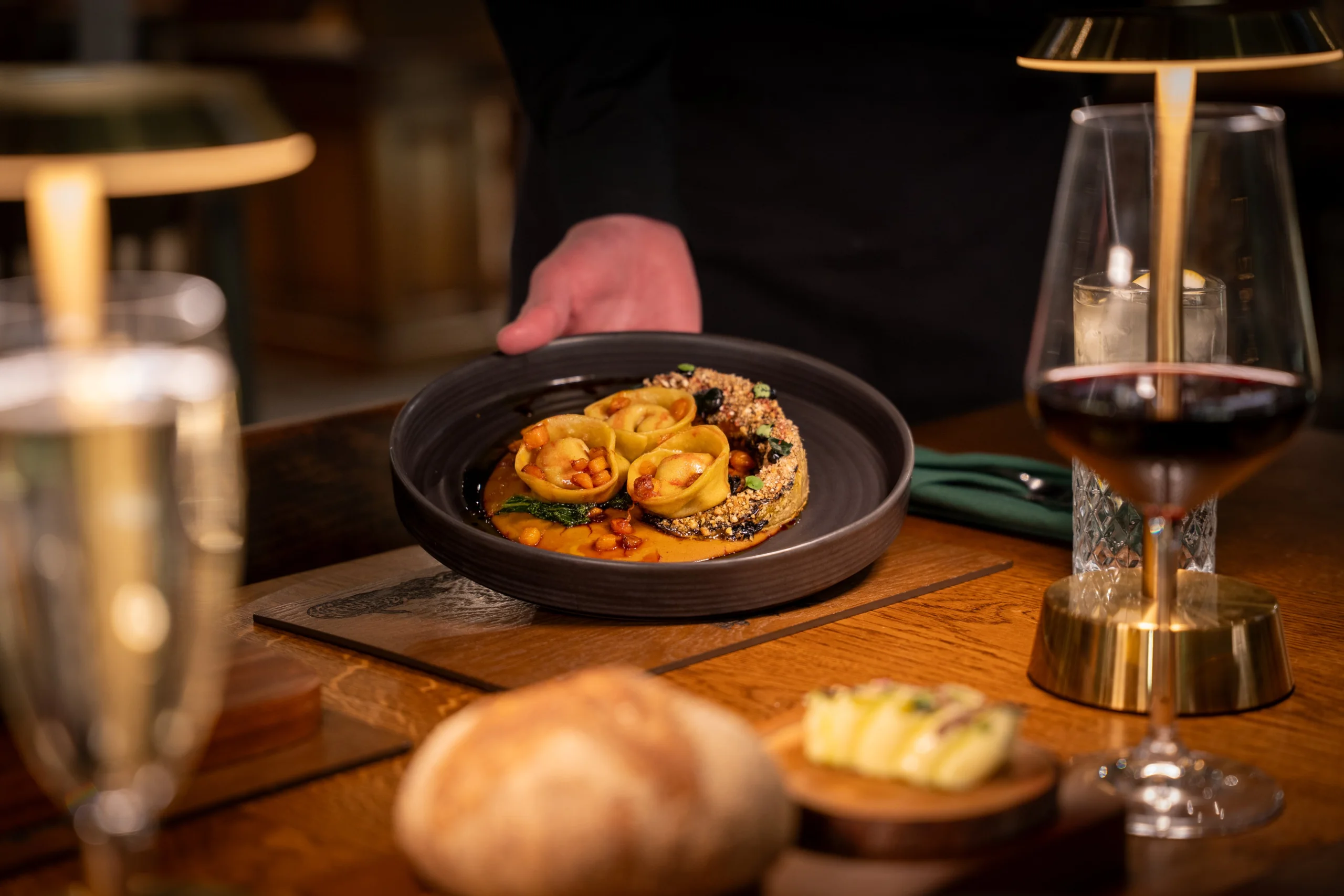 pumpkin gnocchi in a ceramic bowl with red wine