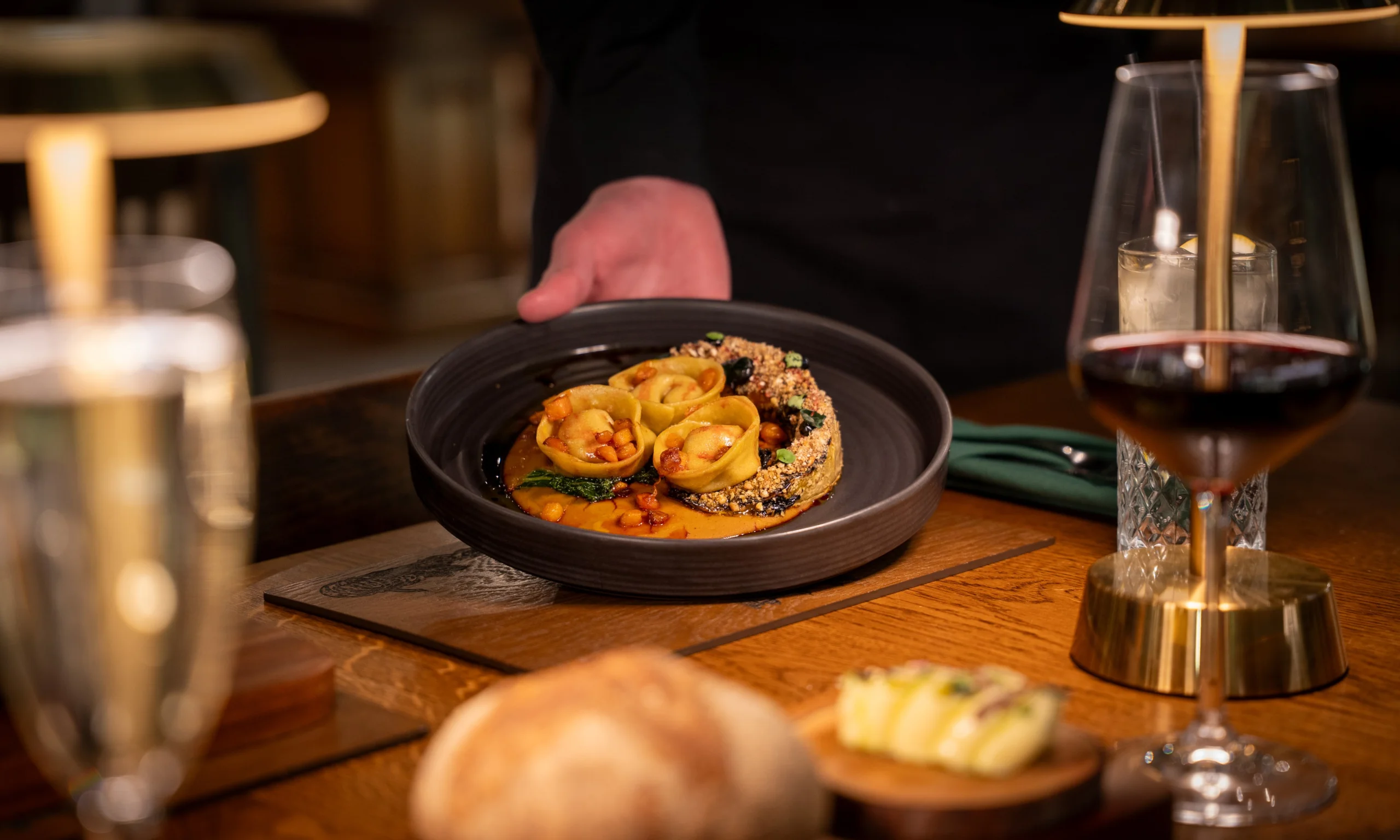 pumpkin gnocchi in a ceramic bowl with red wine