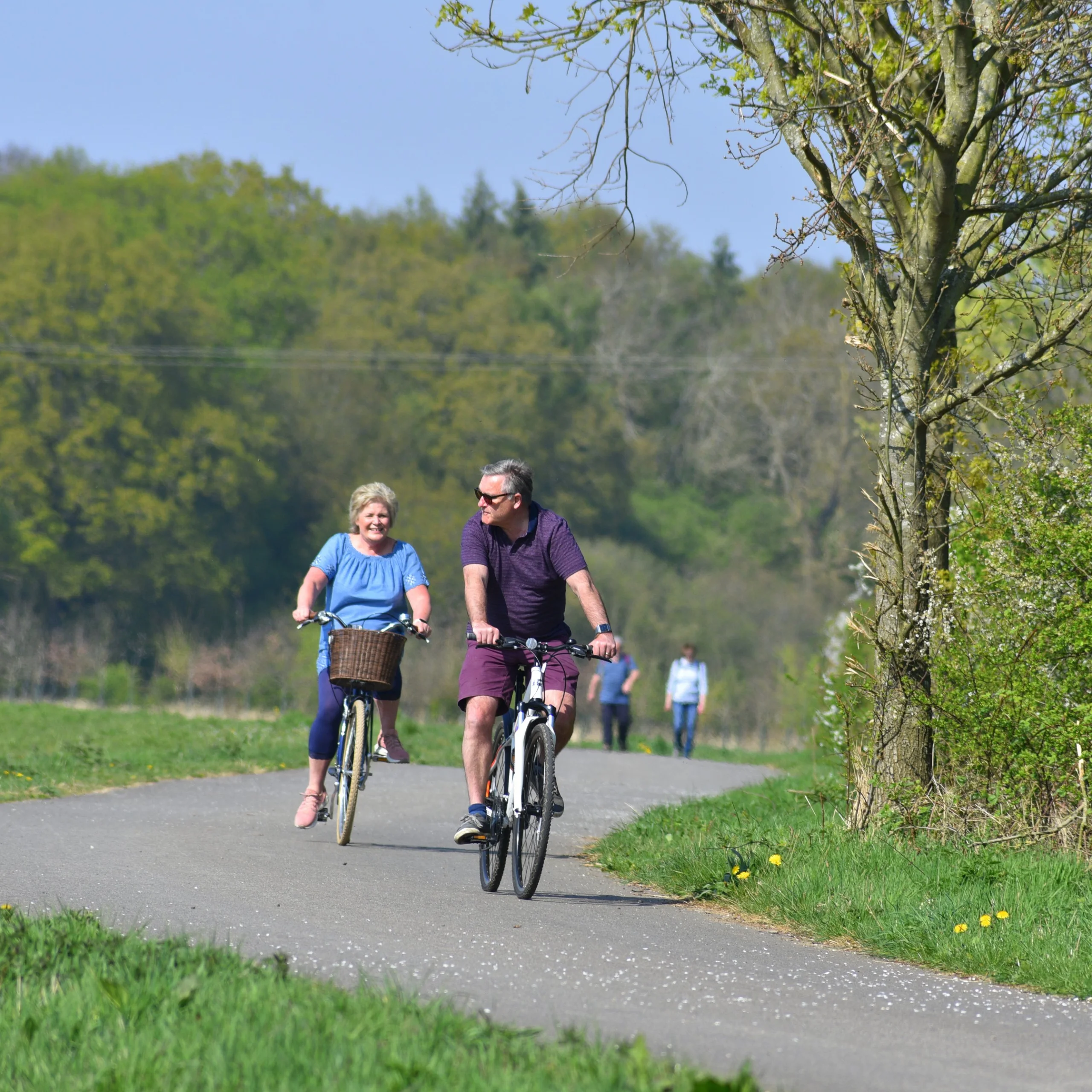 two people enjoying a bike ride on the georgie twigg track at doddington hall