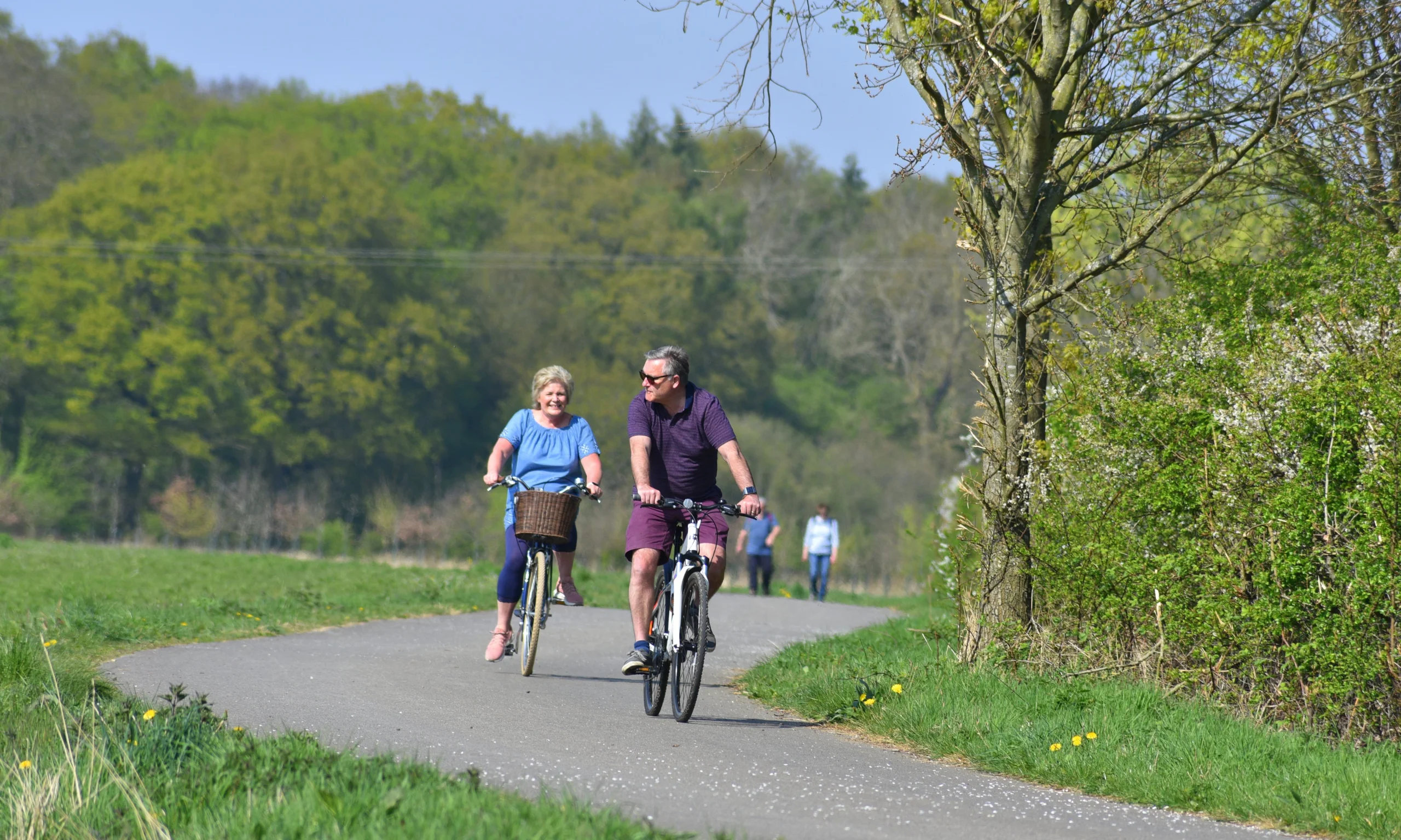 two people enjoying a bike ride on the georgie twigg track at doddington hall