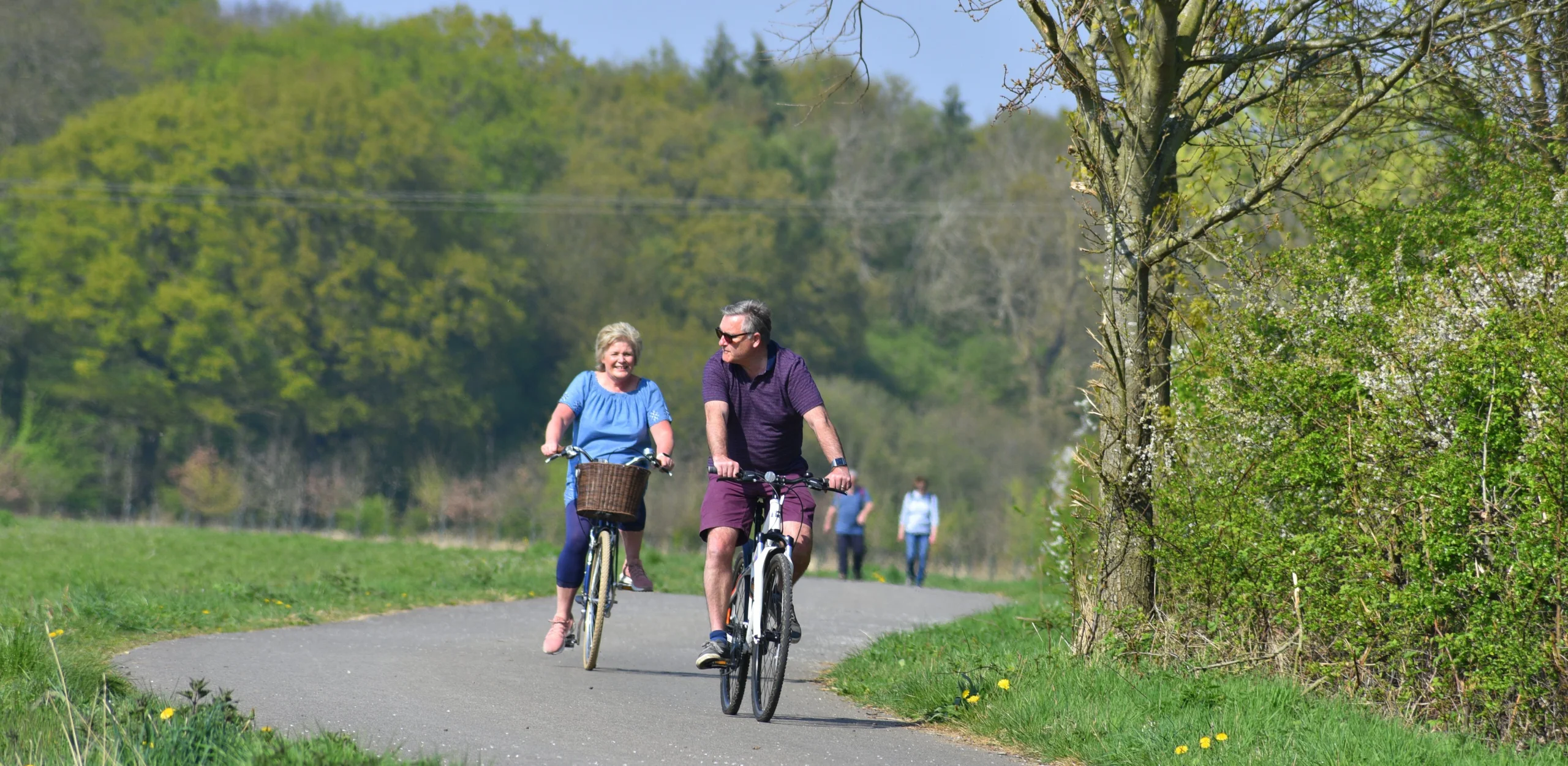 two people enjoying a bike ride on the georgie twigg track at doddington hall