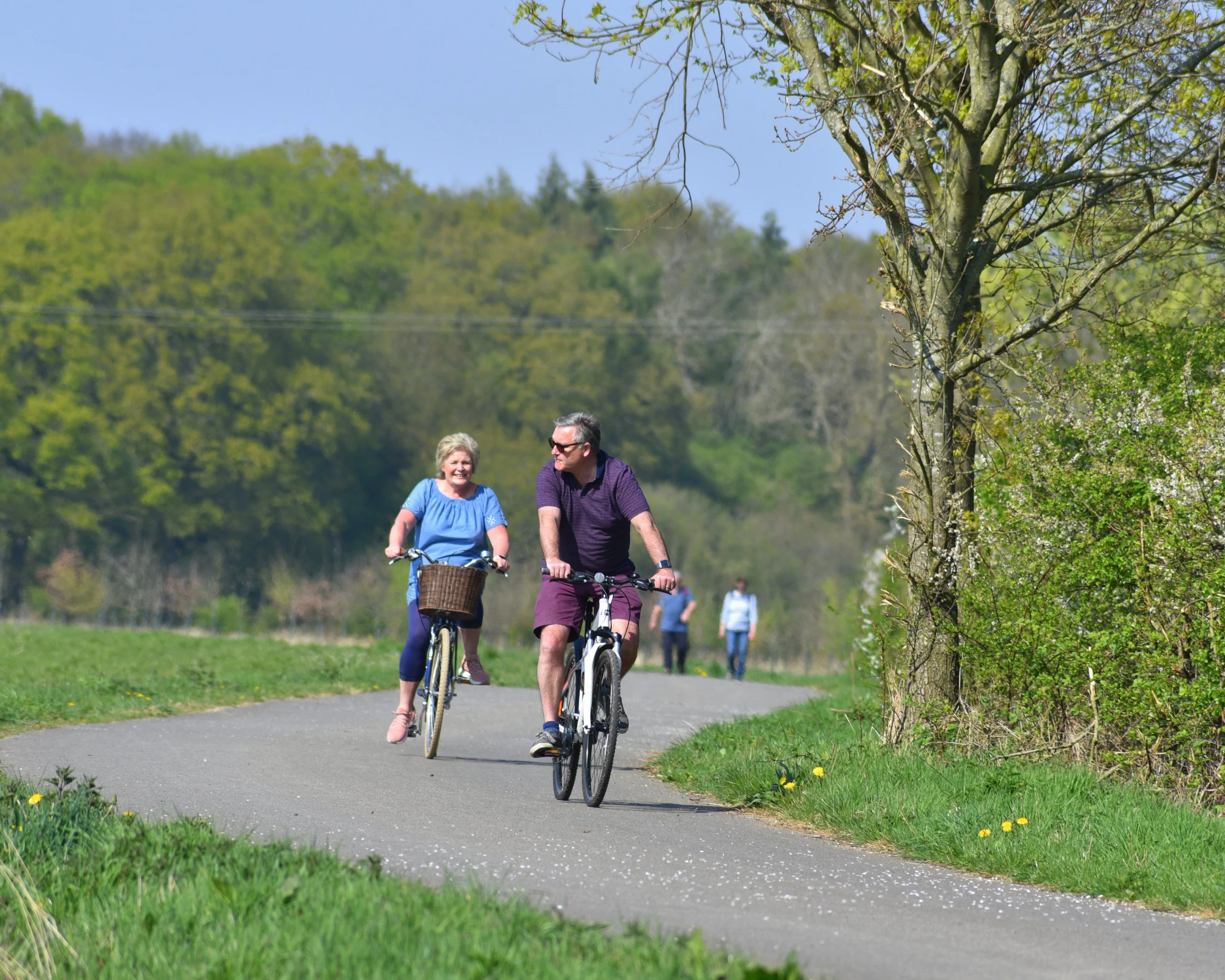 two people enjoying a bike ride on the georgie twigg track at doddington hall