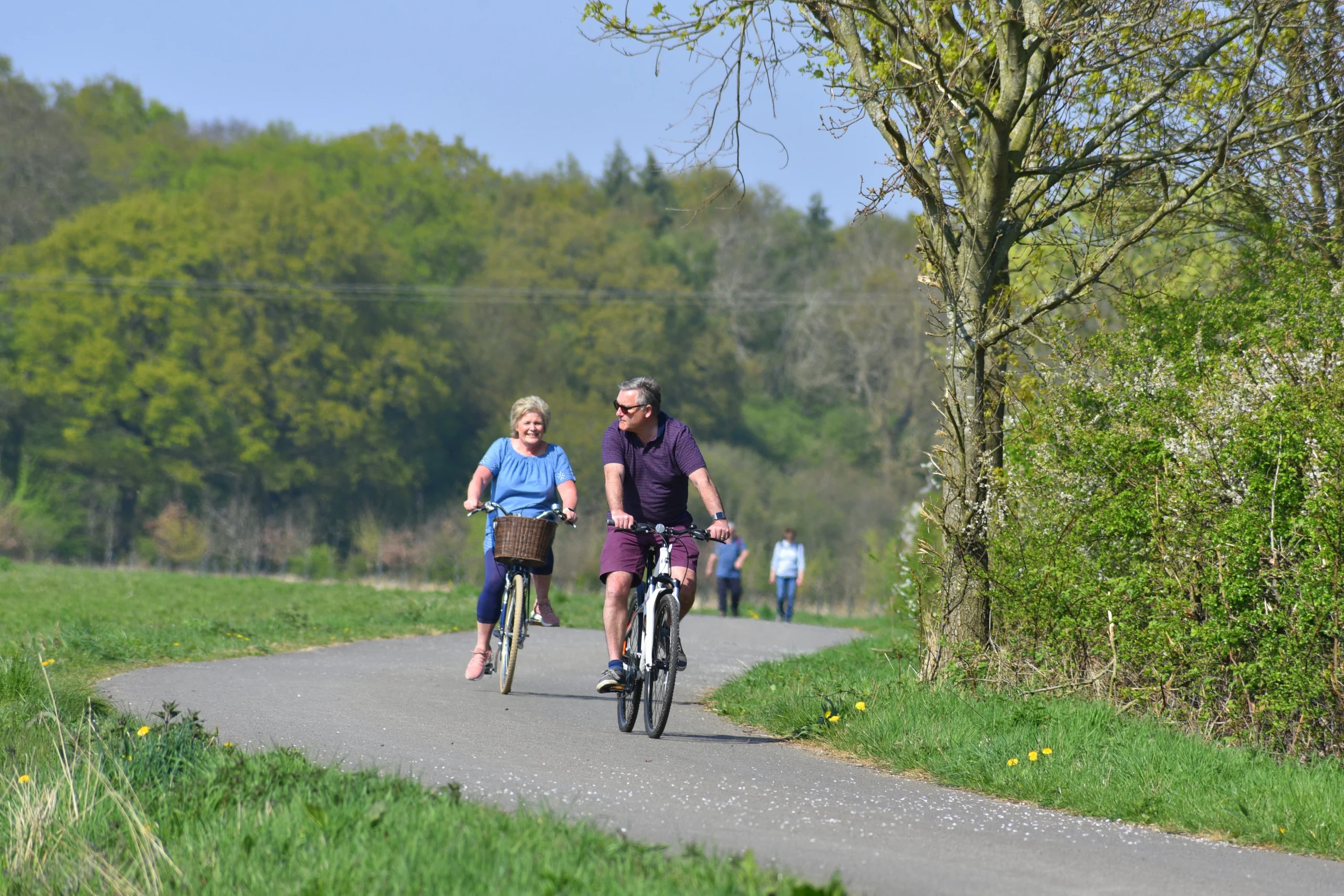 two people enjoying a bike ride on the georgie twigg track at doddington hall