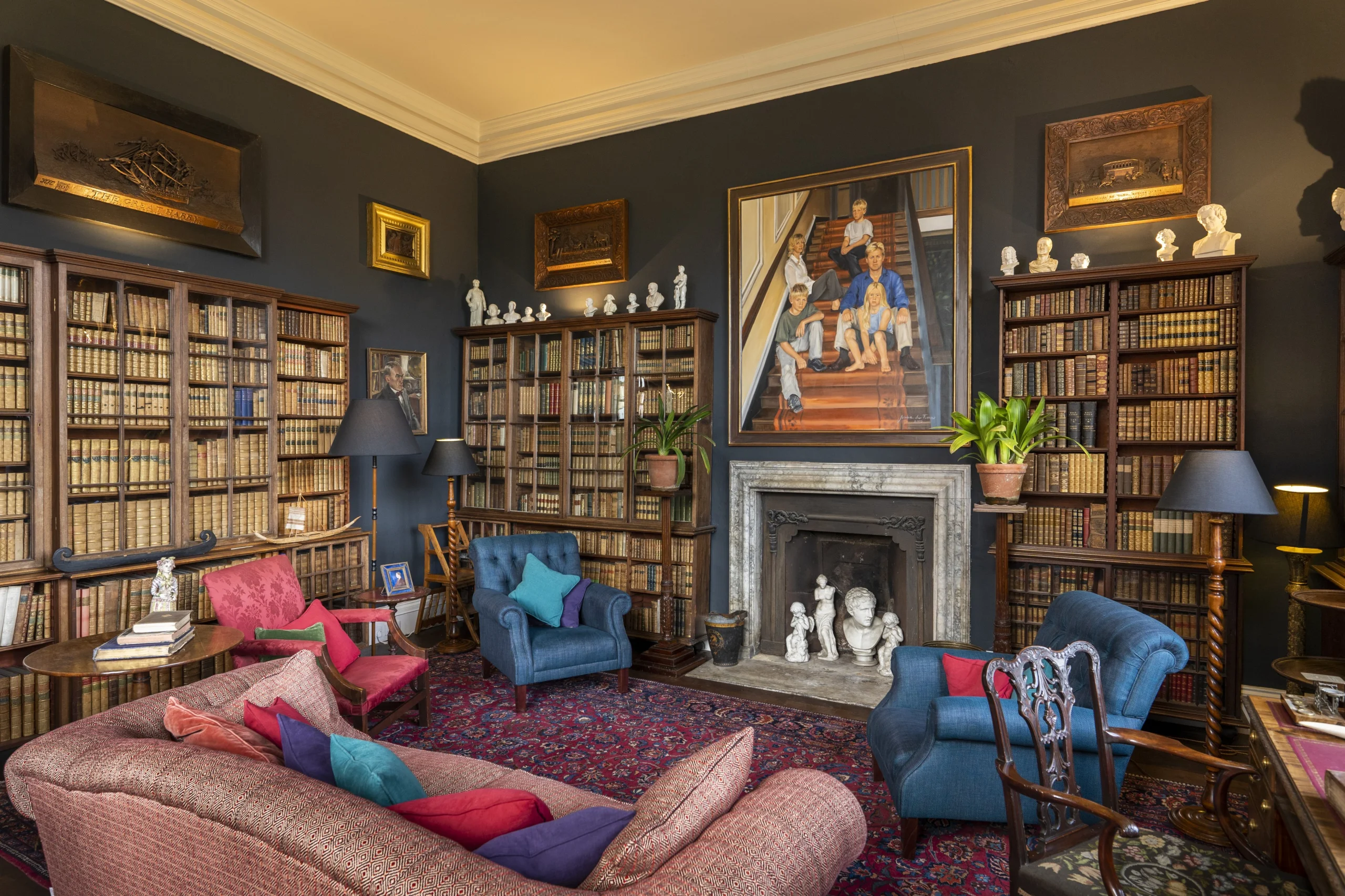 A reading room with book-lined walls and comfortable seating